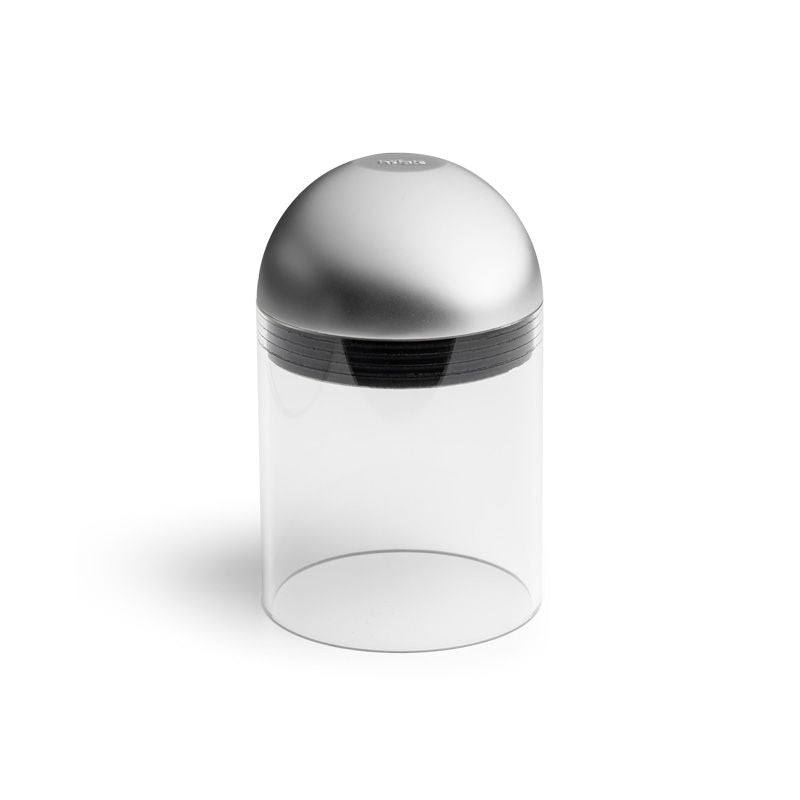 A cylindrical clear container with a metallic dome-shaped lid and black screw threading, reminiscent of the Höfats GRAVITY CANDLE Lantern, ideal for creating ambiance both indoors and outdoors.