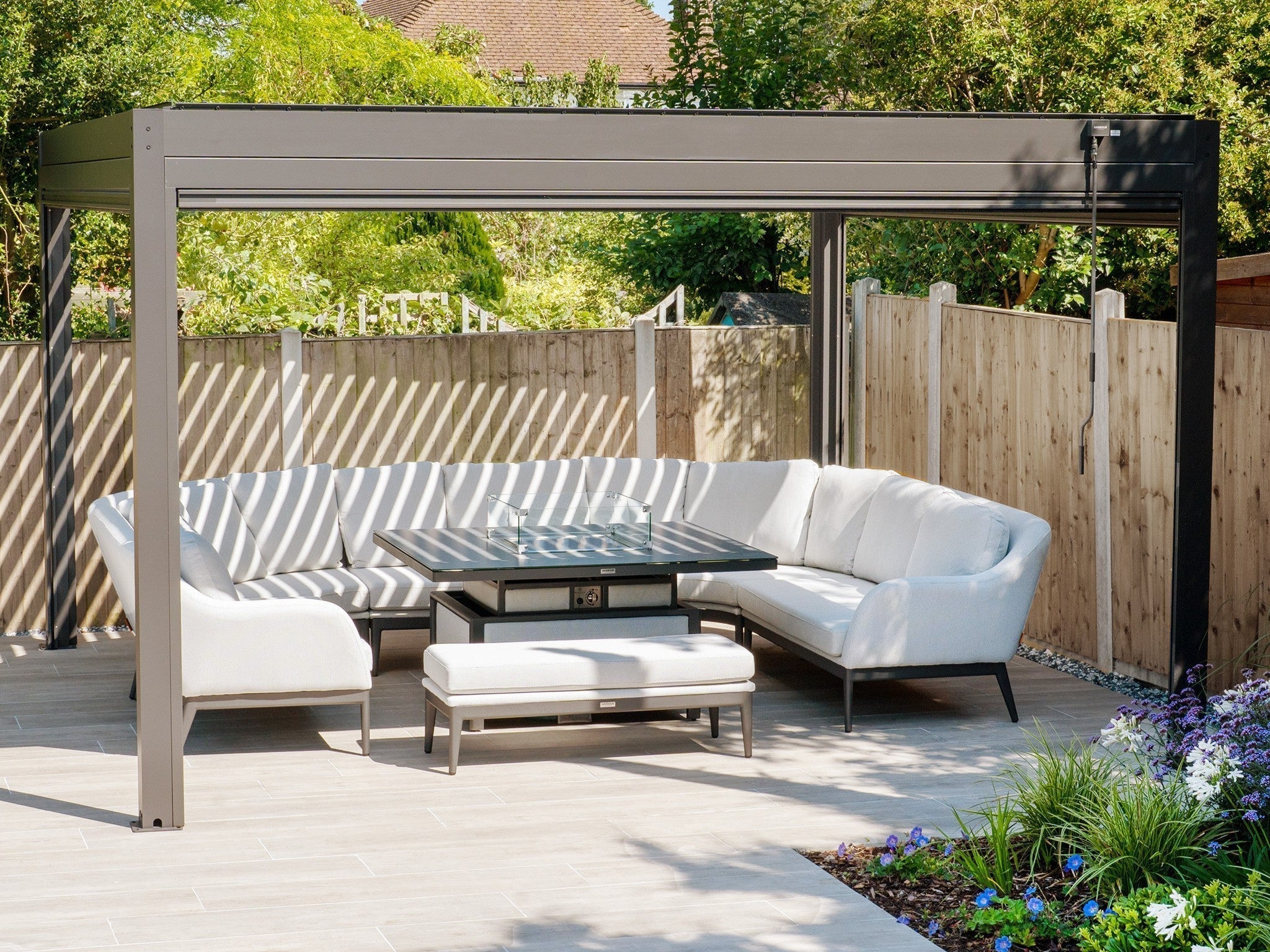 A grey 3m x 4m pergola plus pergola with a luna u-shaped firepit sofa set underneath it