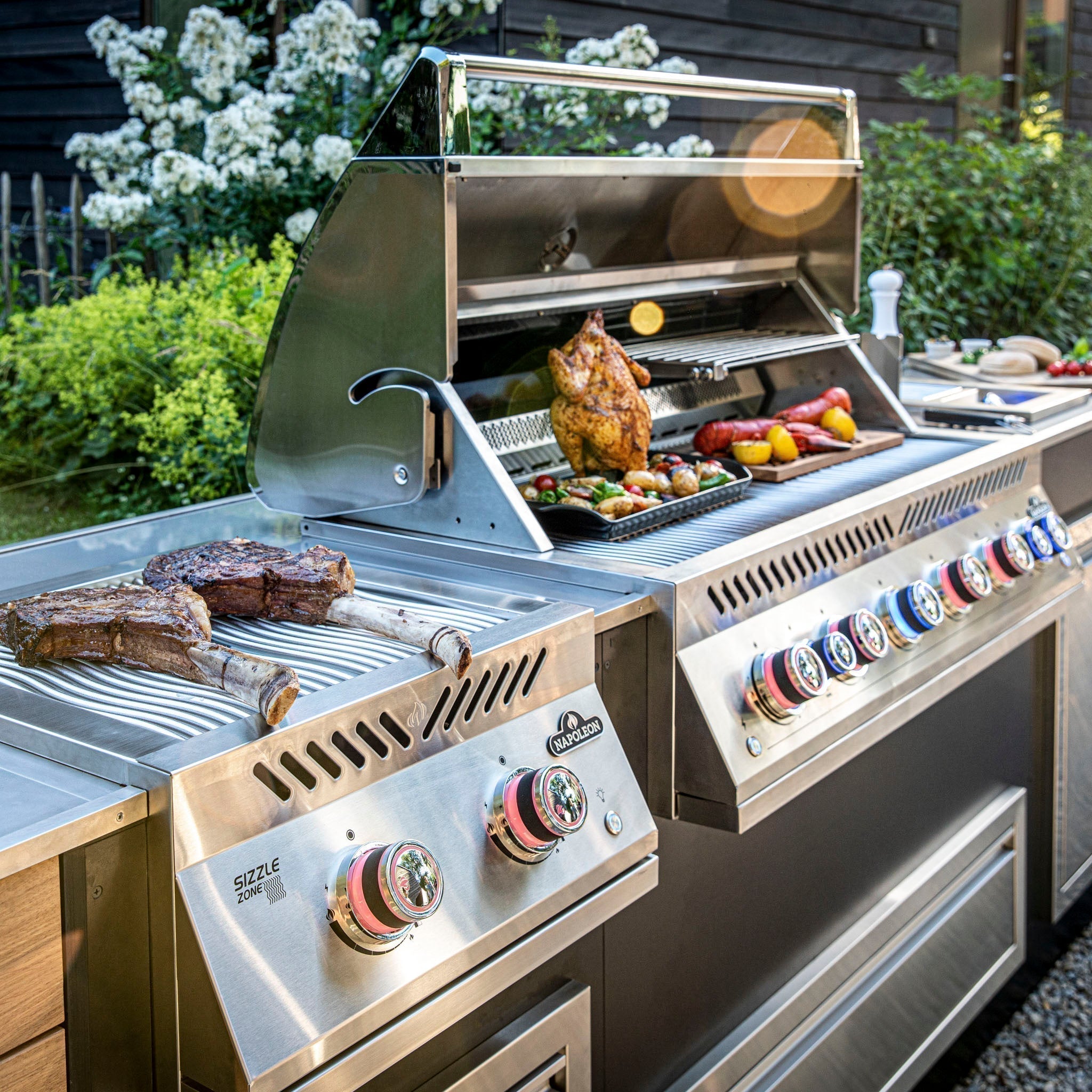 A Napoleon BBQ grill with steaks and a chicken being cooked