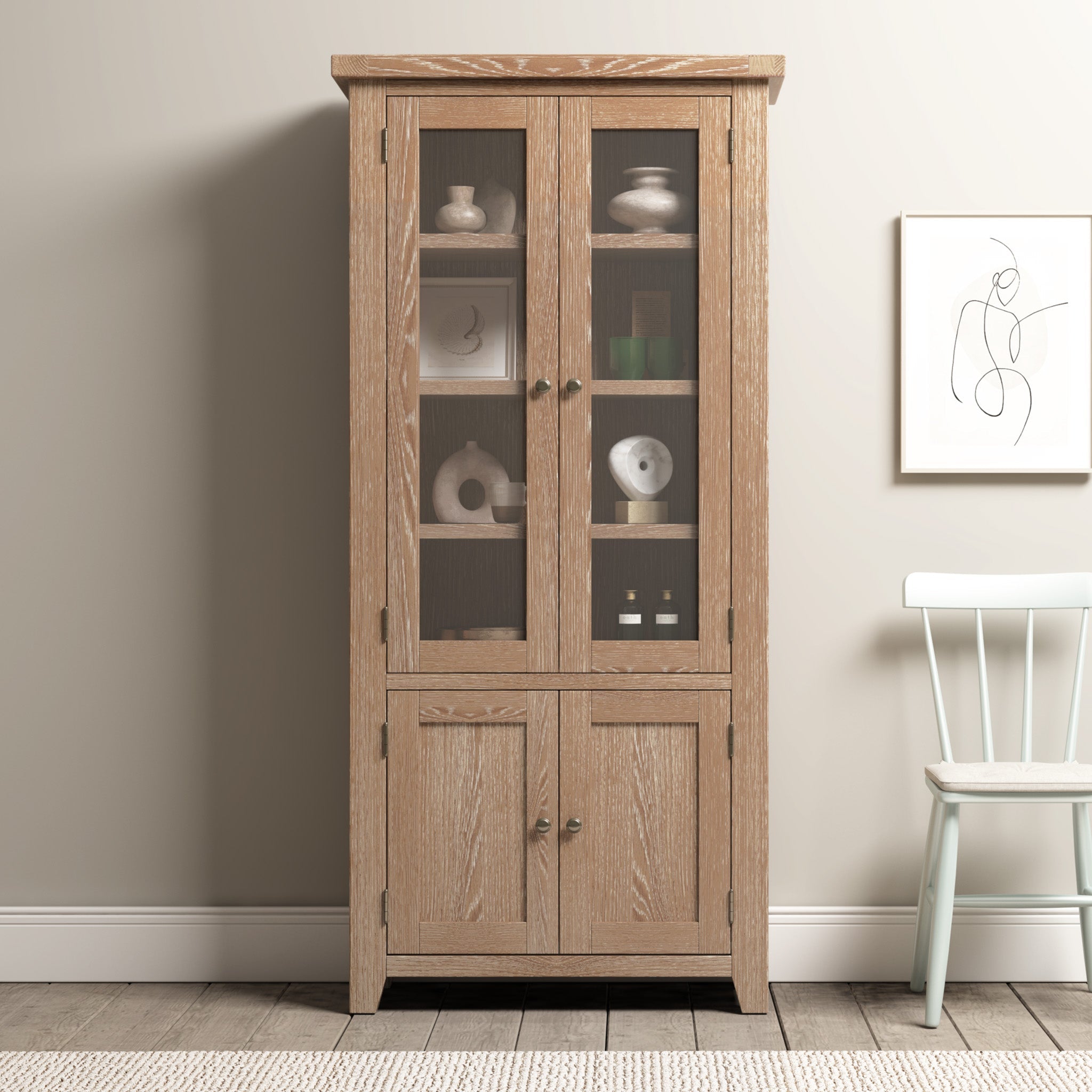 Tall wooden cabinet with glass-paneled doors on top and solid doors below, featuring metal knobs.