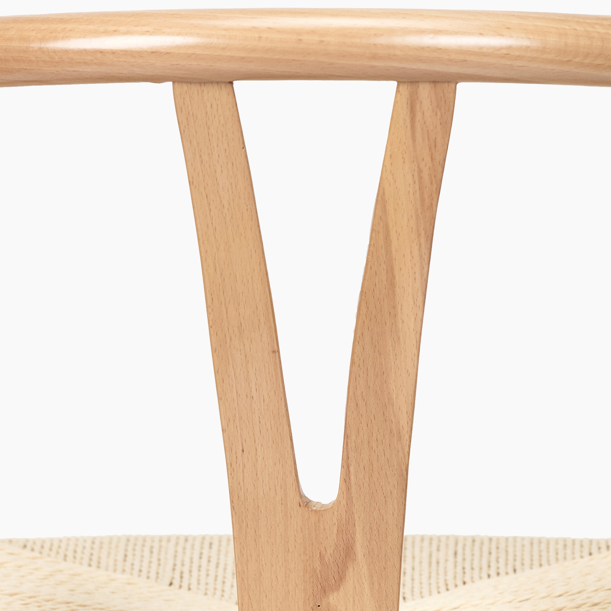 Close-up of the backrest and seat of Pacific Lifestyle's Quinn Dining Chair, showcasing a V-shaped design in beech wood with a beautifully woven natural rope seat.