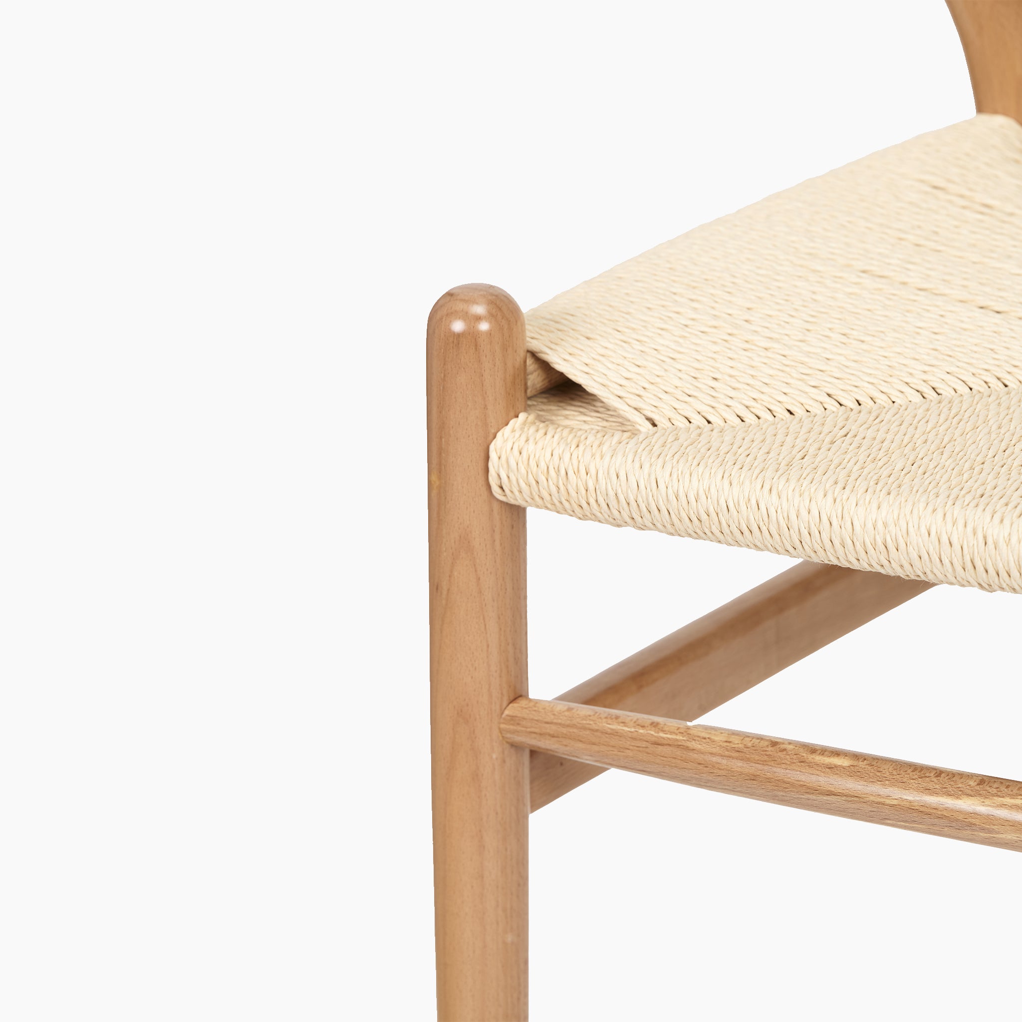 Close-up of a Pacific Lifestyle Quinn Dining Chair corner, crafted from natural beech wood and woven natural rope, set against a plain white background.