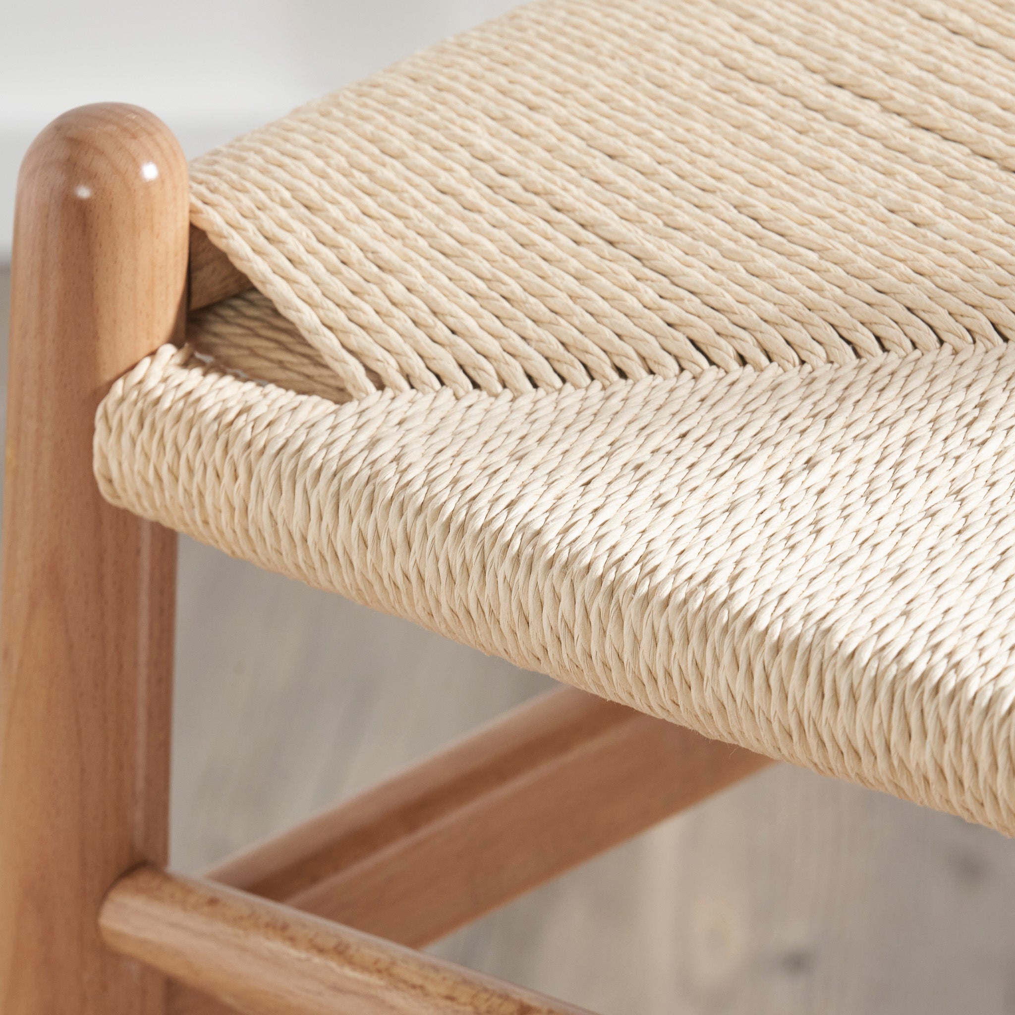 Close-up of the Pacific Lifestyle - Quinn Dining Chair, highlighting its woven rope seat and detailed texture with a natural beech wood finish.