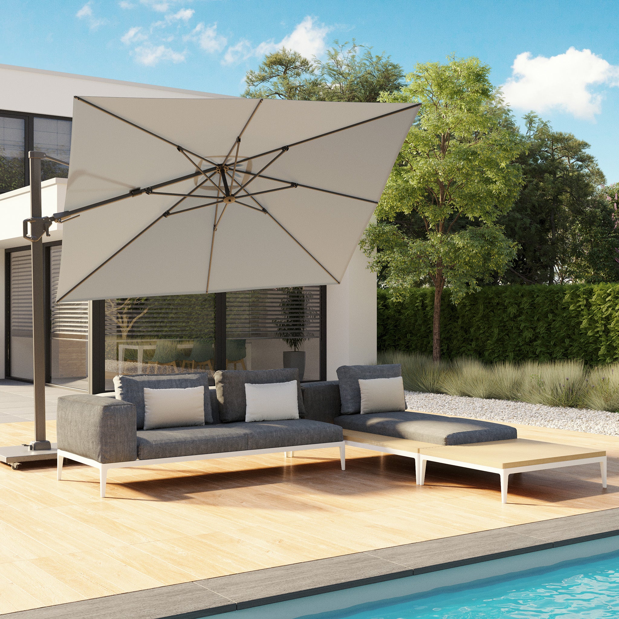 Lounge by the pool under the Pacific Lifestyle Challenger T2 3m Square Cantilever Parasol in Grey with UV protection, surrounded by modern gray sofas on a wooden deck near a contemporary house.