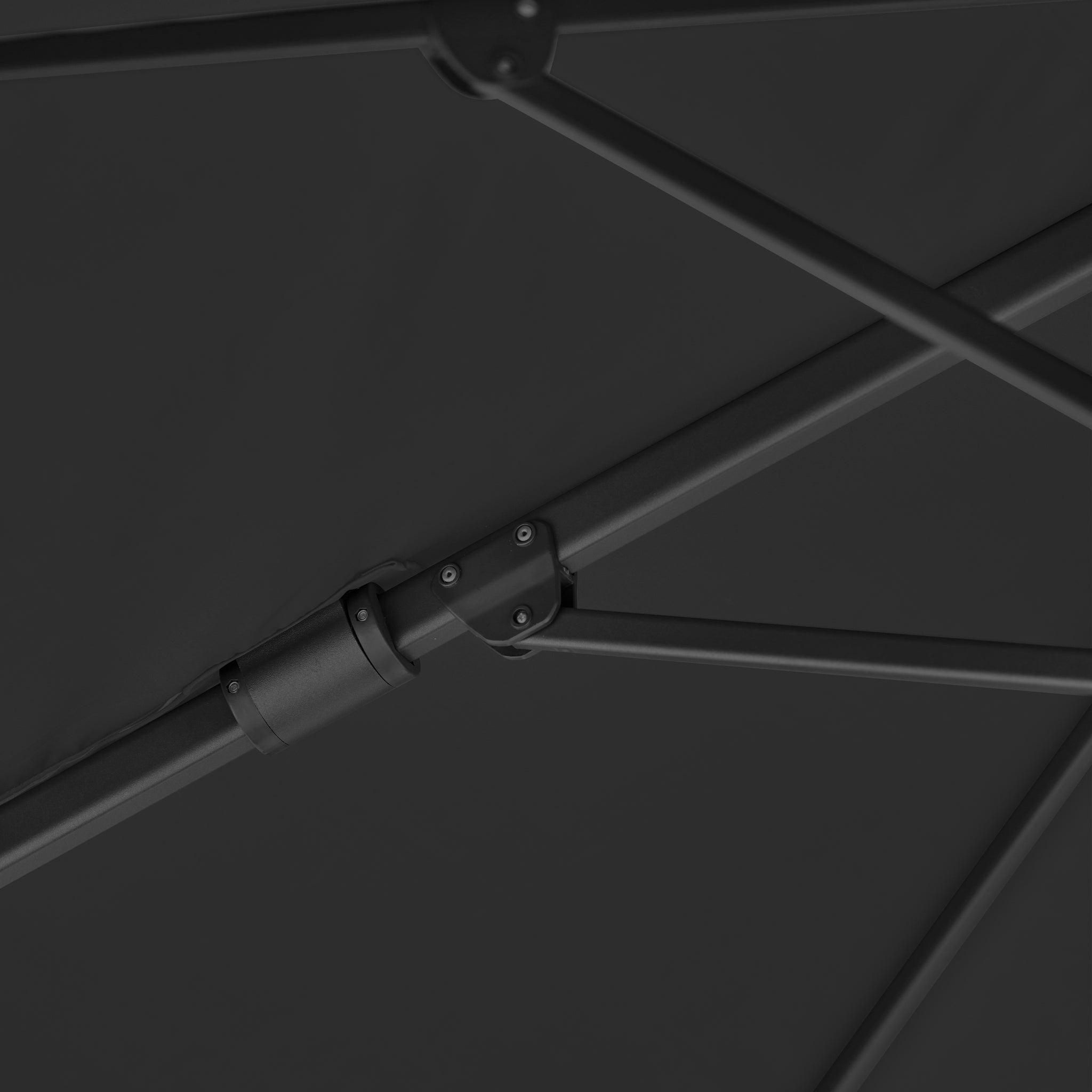 Close-up of dark metal support rods and a joint beneath the Challenger T2 Premium 3.5m x 2.6m Rectangular Cantilever Parasol in Black canopy.