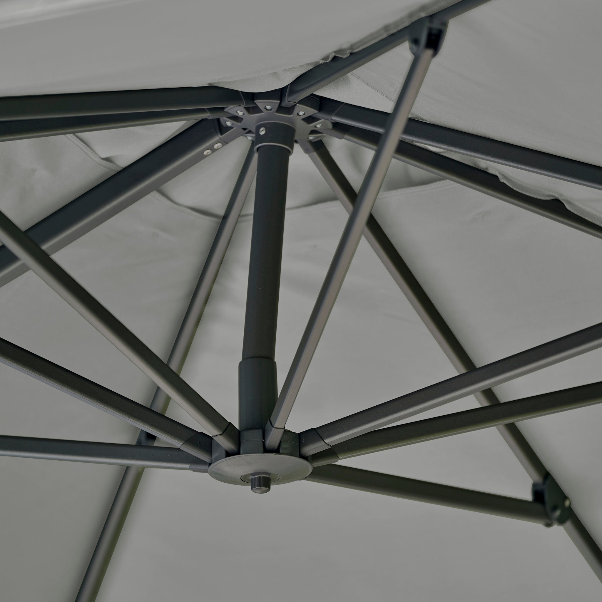 Close-up view of the underside of the Challenger T2 Premium 3.5m x 2.6m Rectangular Cantilever Parasol in Manhattan Grey, showing its metal support ribs and central pole.