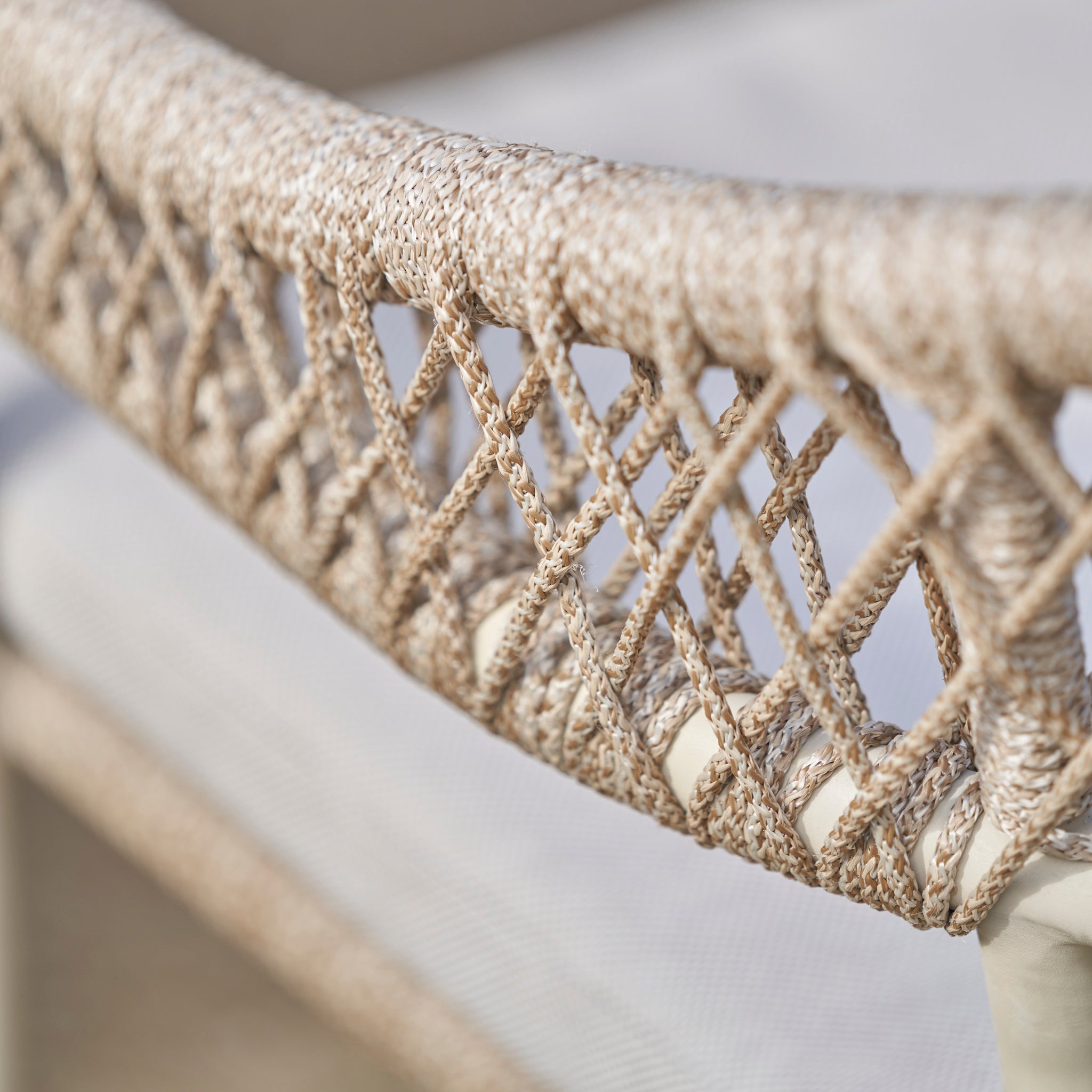 Close-up of a woven rattan chair backrest with a diamond pattern and neutral tones, ideal for pairing with the Pacific Lifestyle - Osaka 6 Seat Dining Set in Latte for stylish outdoor dining.