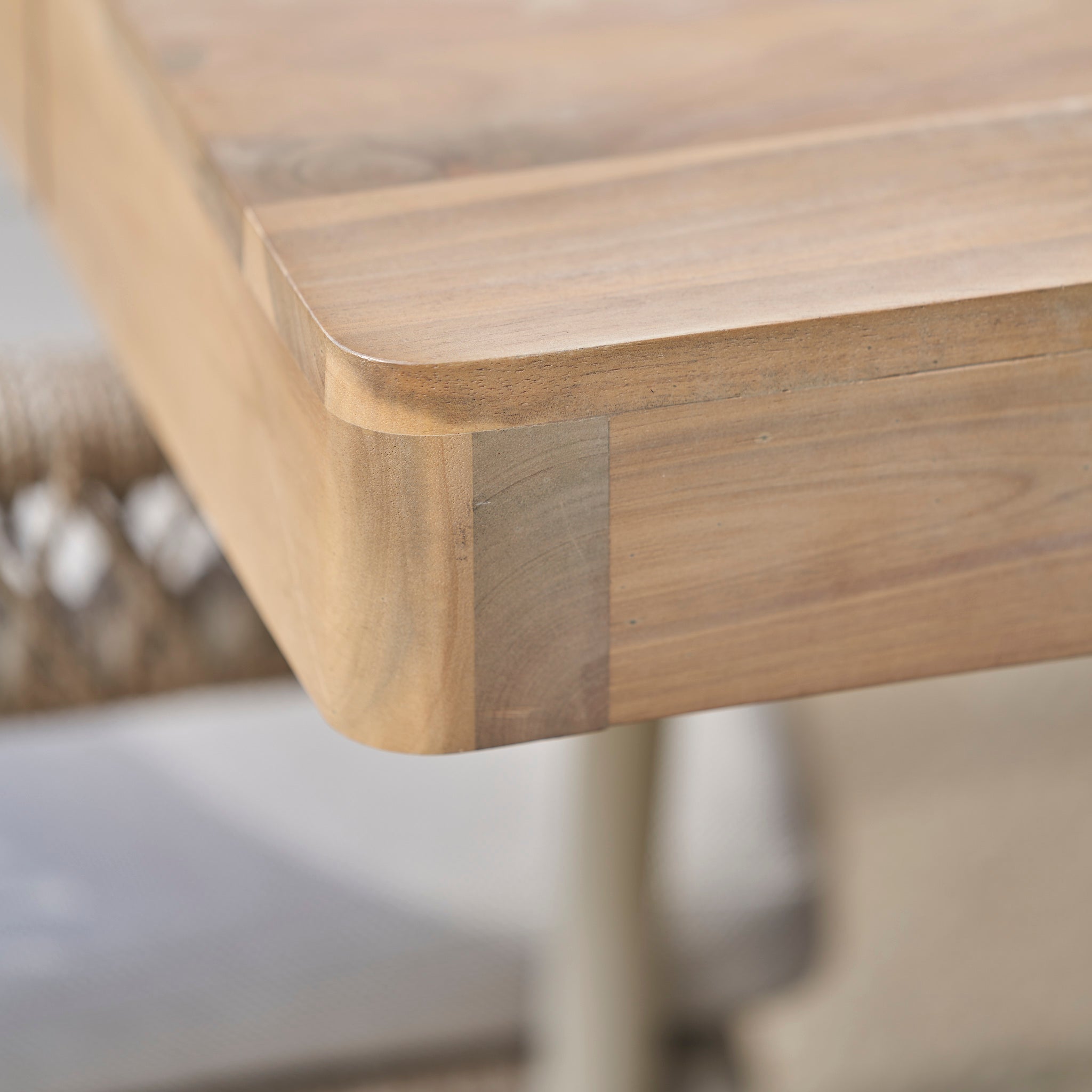 Close-up of a Pacific Lifestyle - Osaka 6 Seat Dining Set in Latte showing smooth, rounded acacia wood corners and visible grain—perfect for stylish outdoor dining.