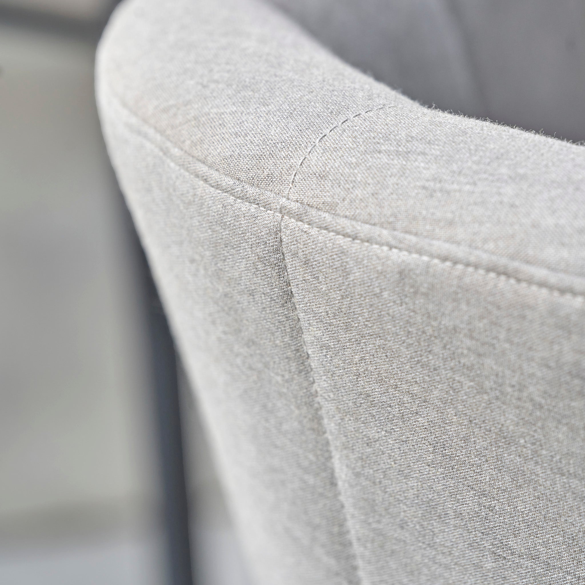 Close-up of a light gray fabric chair back with visible stitching and a soft, textured surface, perfect for complementing the Kai 4 Seat Round Dining Set in Light Grey.