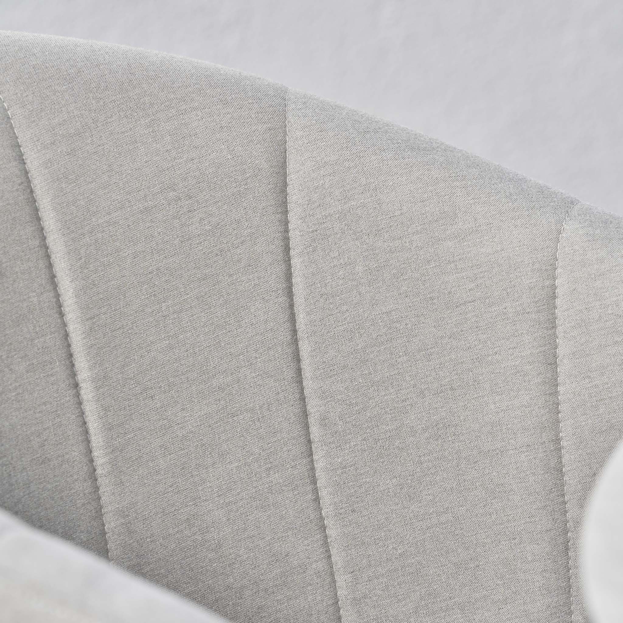 Close-up of a light gray upholstered chair with vertical stitched seams on the curved backrest, perfect as part of the Kai 4 Seat Round Dining Set in Light Grey.