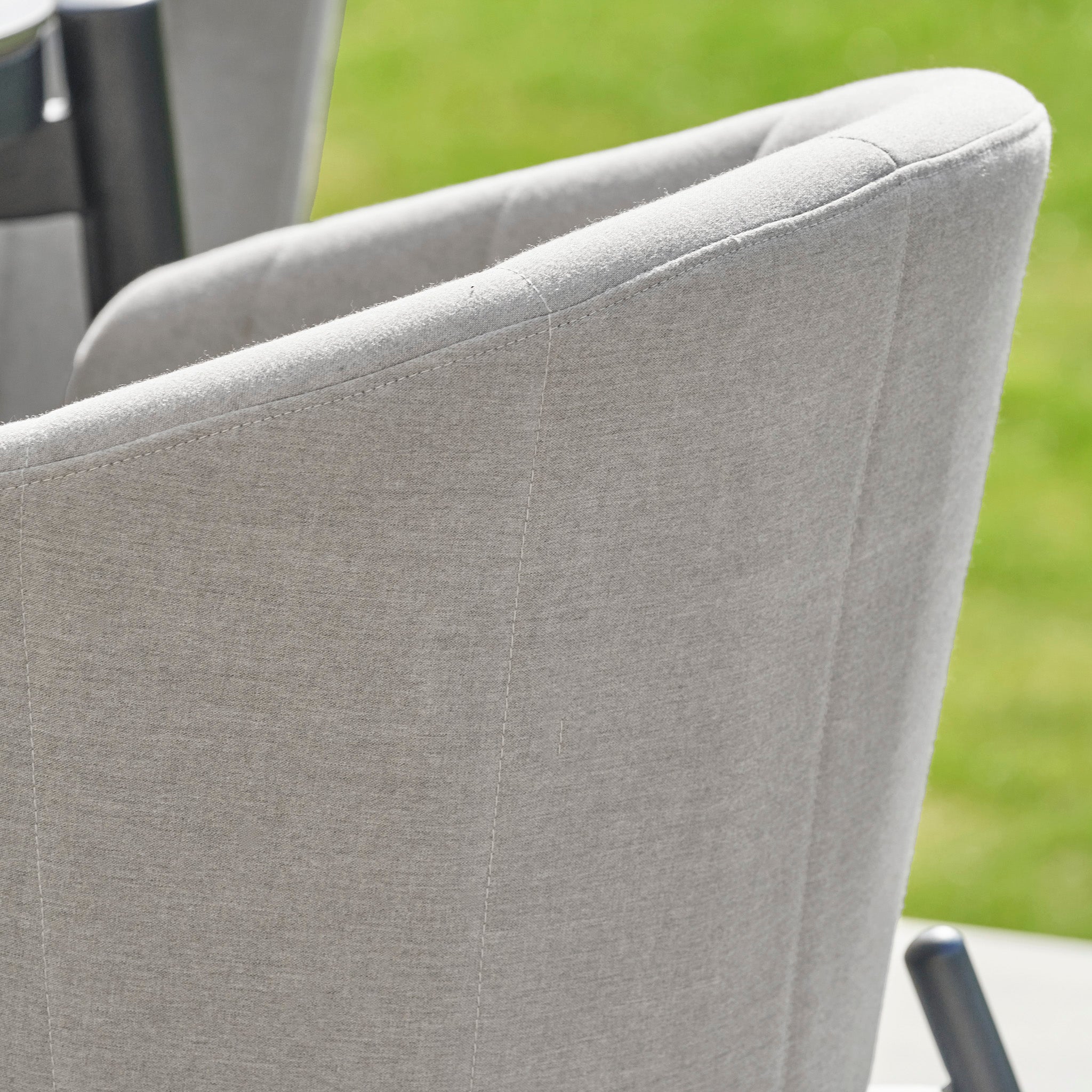 Elevate your outdoor dining experience with the Kai 6 Seat Rectangular Dining Set in Light Grey. Featuring a sleek upholstered design and set against lush green grass, this elegant set is an ideal addition to your garden furniture collection or the perfect accent for any outdoor dining area.