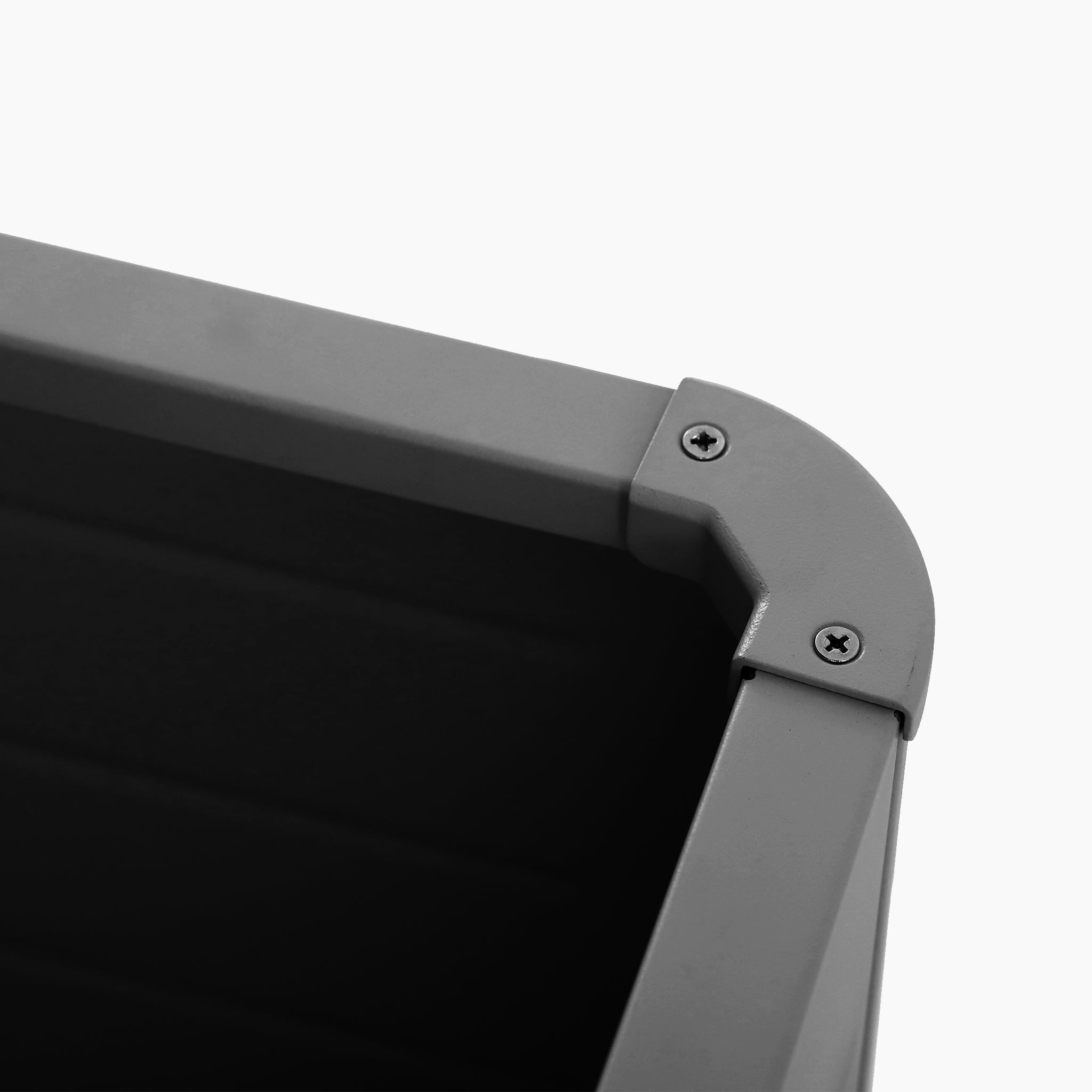 Close-up of a Pacific Lifestyle - Rhode Island Large Outdoor Cushion Box in Anthracite, showing the gray plastic corner with visible screws—perfect for outdoor cushion storage.