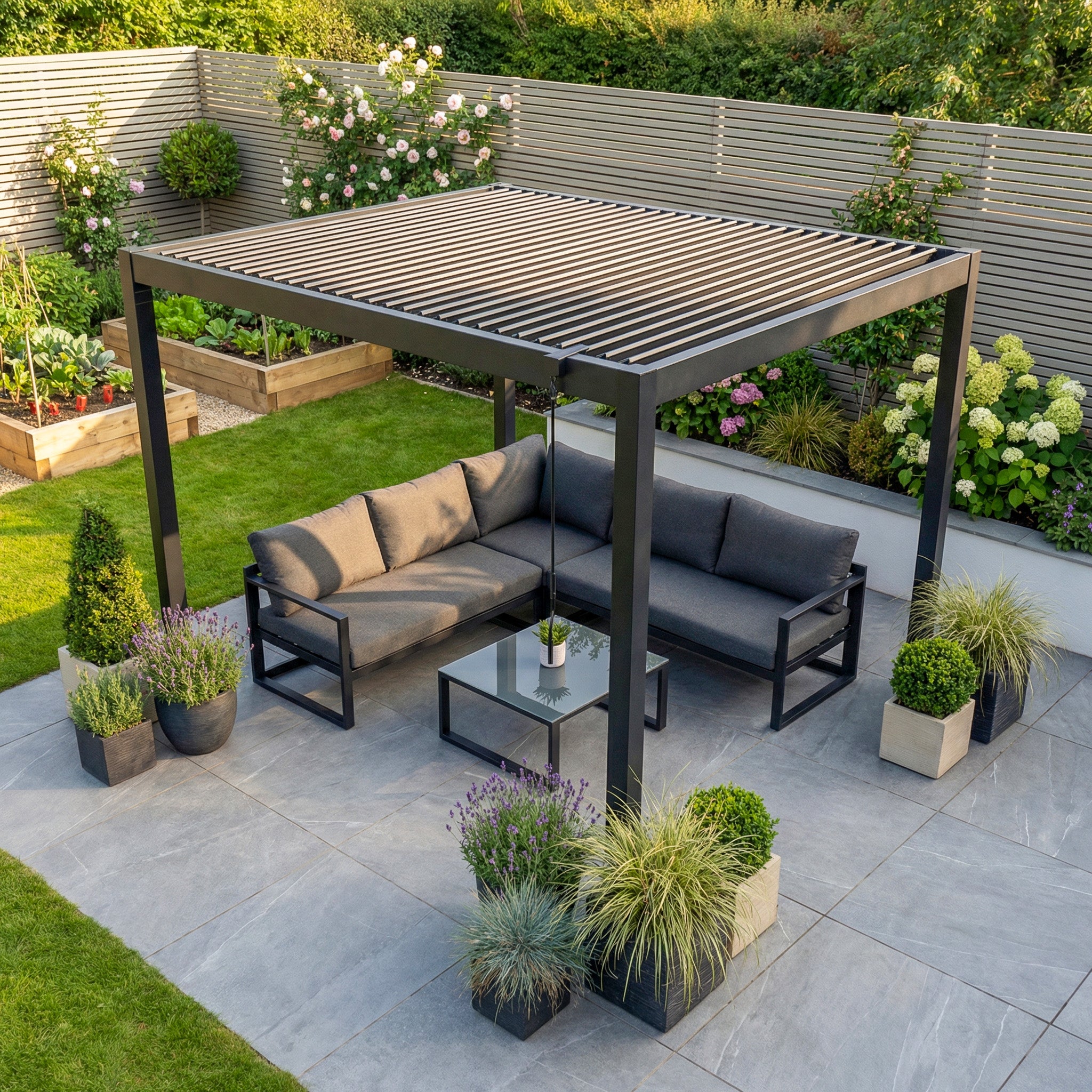The PergoSTET Lite 2.4m x 3m Metal Rectangular Pergola in Grey, with tilting louvres, offers adjustable outdoor shade for comfort and relaxation on a stylish patio featuring sofas, a coffee table, and potted plants.