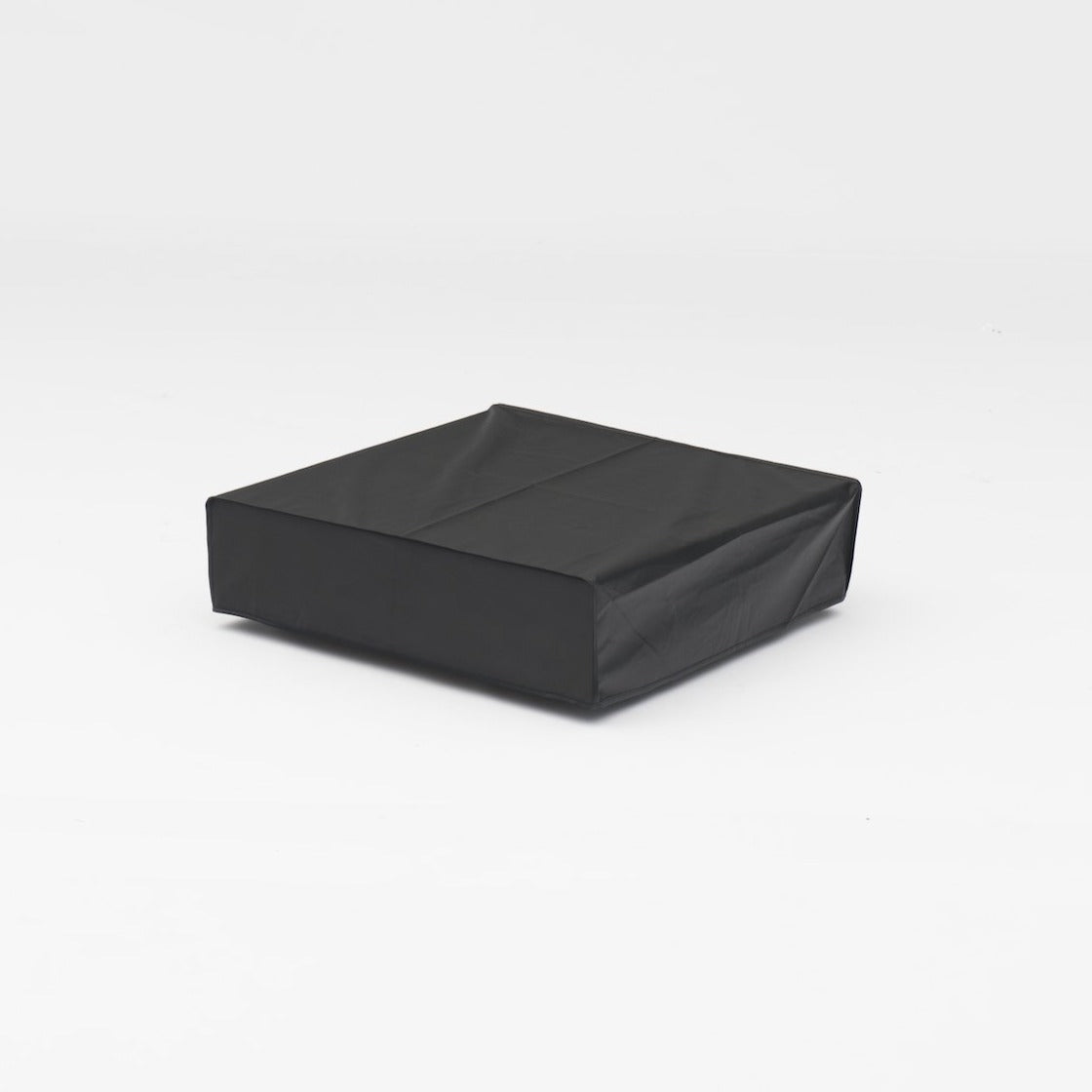 The square black cushion elegantly rests against a white backdrop, subtly complementing your Panama Coffee Table's Weatherproof Cover with sophistication.