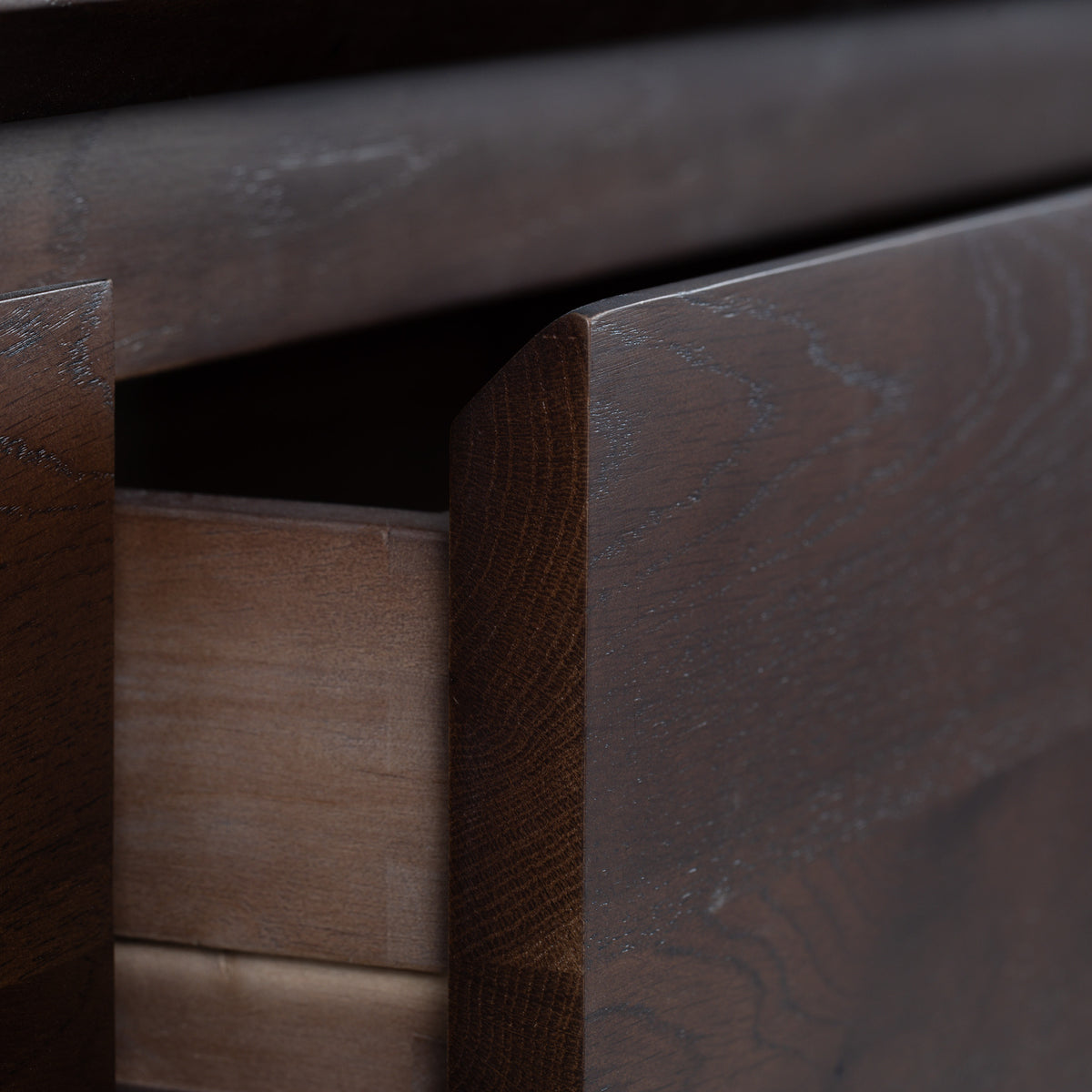 A close-up of a partially open wooden drawer in the Oslo 2 Drawer Console Table in Walnut, ideal for use as hallway furniture or as part of an elegant accent piece.