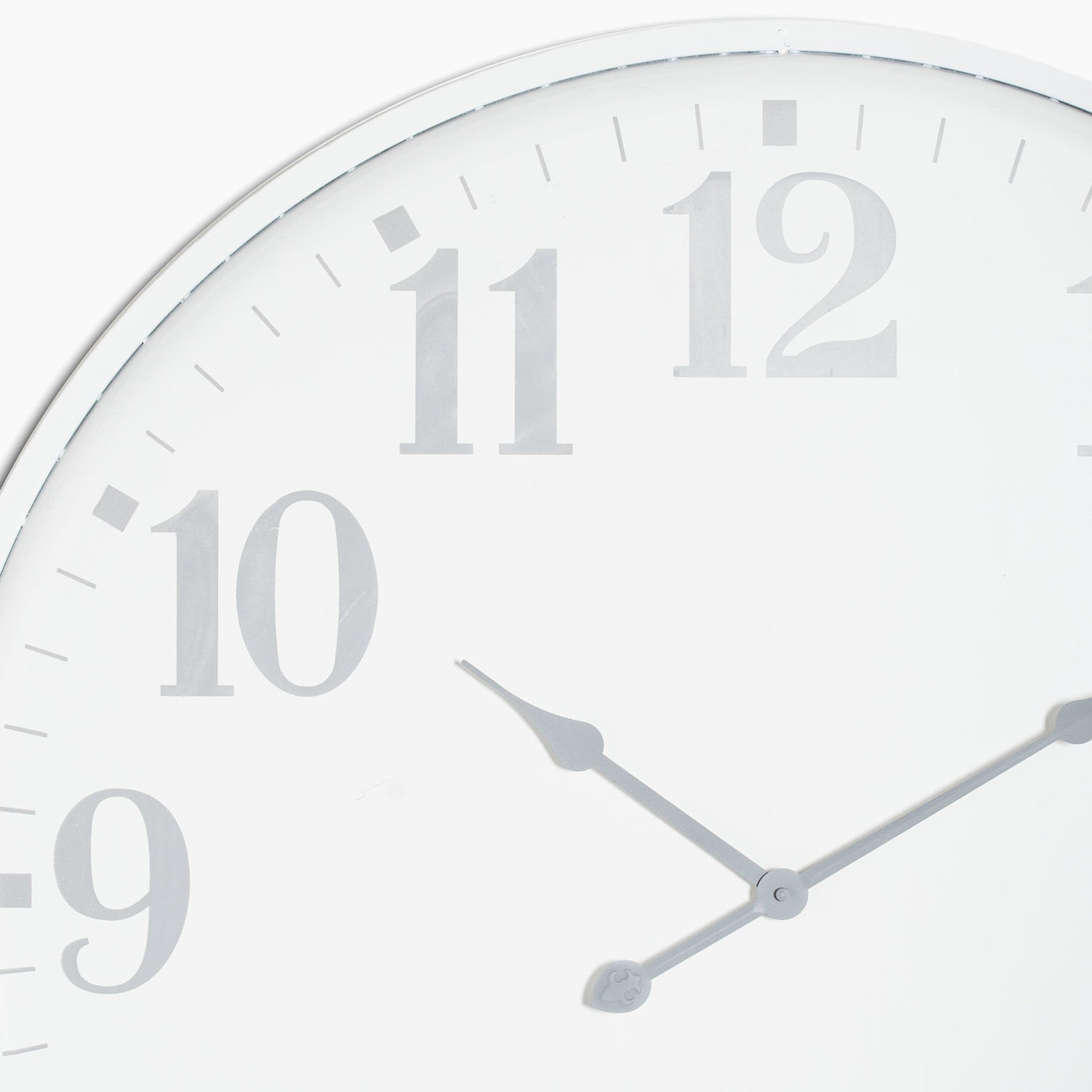 A close-up of the Aubrey Large Wall Clock highlights its elegant silver-effect metal frame and minimalist design, with silver hour and minute hands indicating the time as approximately 1:50.
