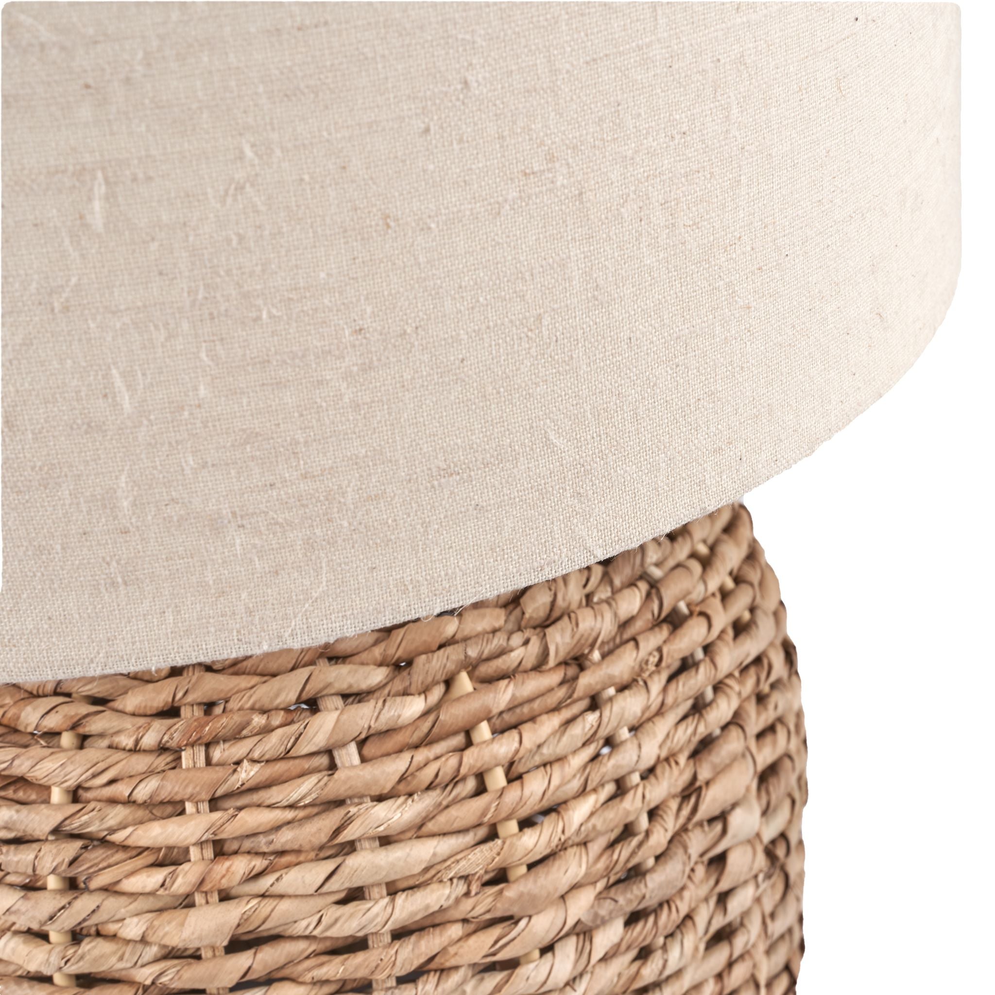 Close-up of a Pacific Lifestyle Acer Natural Woven Small Table Lamp in Ivory, showcasing its rustic wicker design with a partially visible beige fabric cover on top.