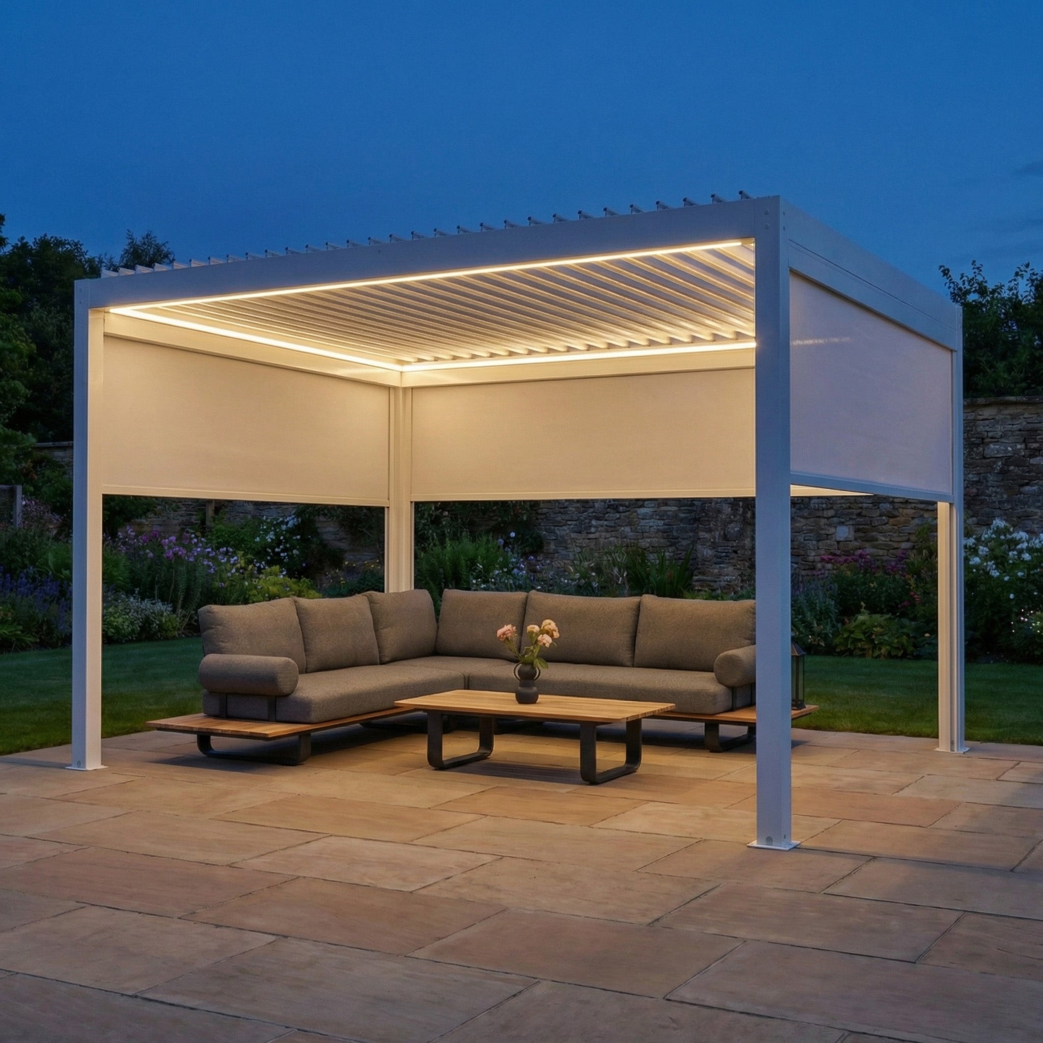 PergoSTET Plus 3m x 4m Rectangular Pergola with 3 Manual Side Blinds and LED Lighting in White, illuminated at night over an outdoor seating area.