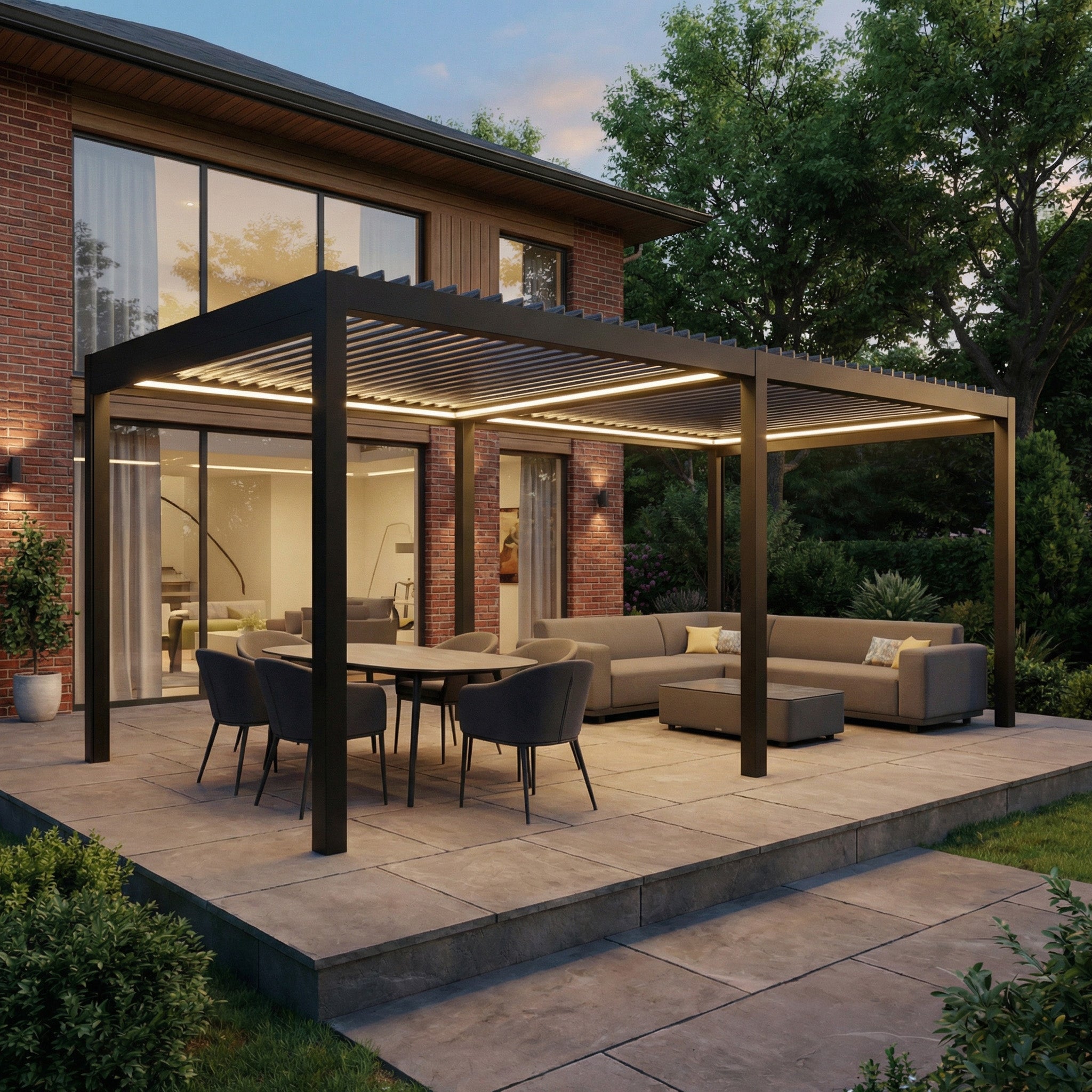 Modern outdoor patio with a PergoSTET Pro Frame Only 3m x 6m Rectangular Pergola in Grey, featuring aluminium louvres and LED lighting, plus dining table and sofas, beside a contemporary brick house.