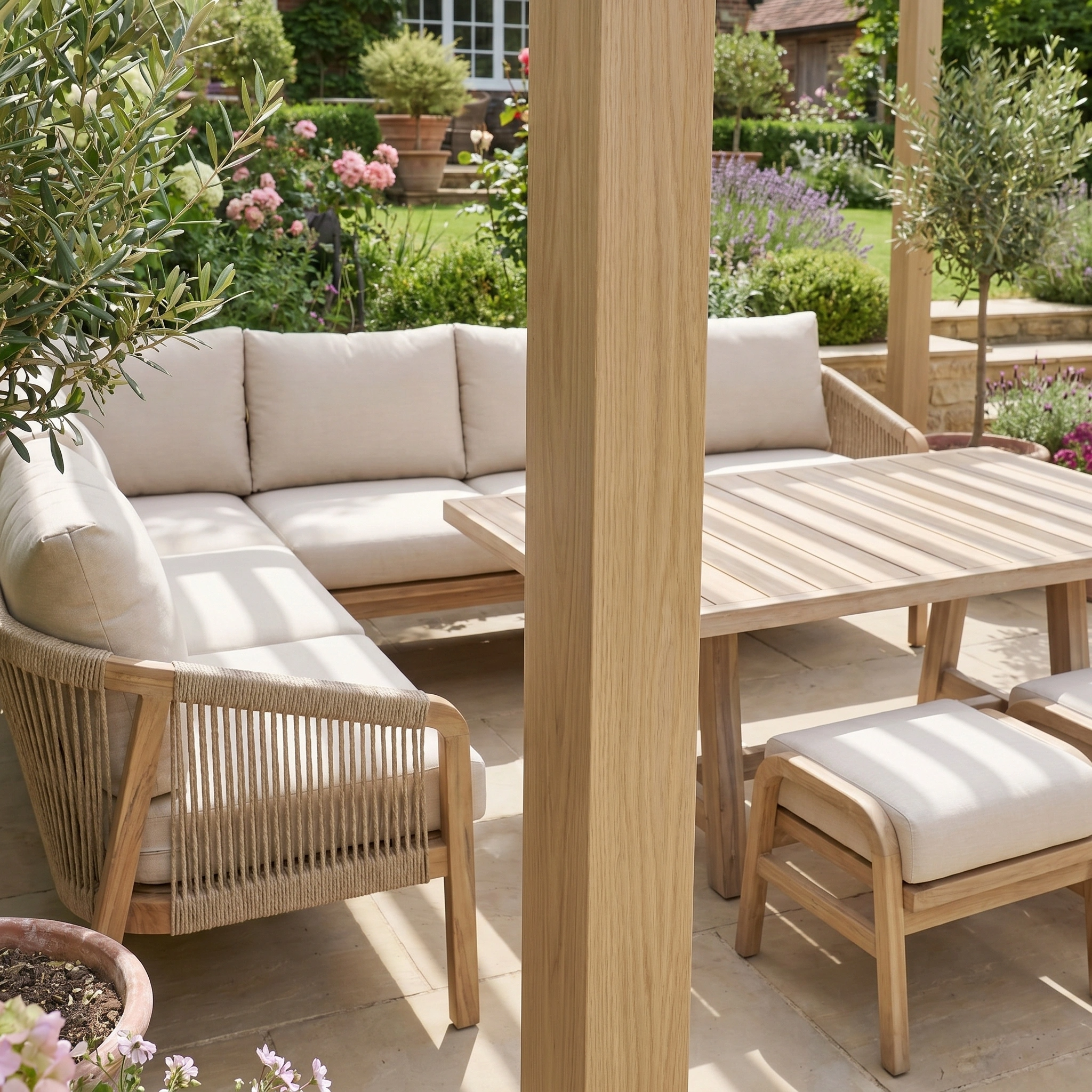 Outdoor patio with a wooden table and cushioned chairs in a garden, shaded by the PergoSTET Lite Neo 3m x 3m Metal Square Pergola in Wood Effect, featuring tilting steel louvres for adjustable shade.