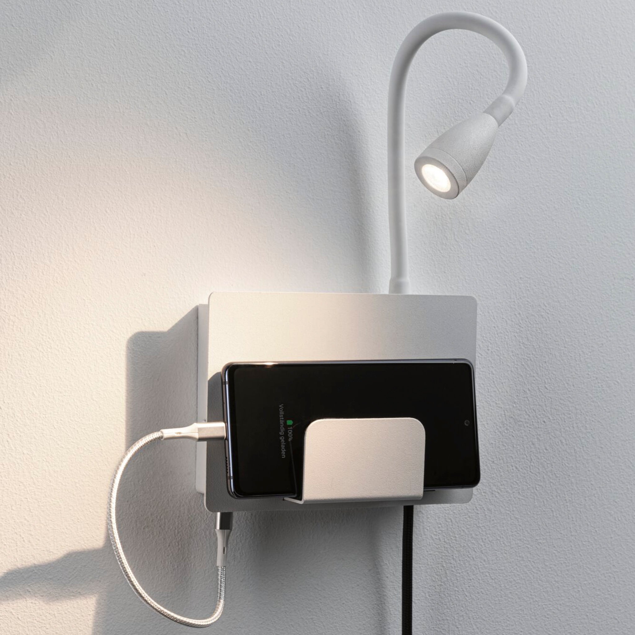 The Paulmann - Halina 3.5W LED Wall Light in white matt includes a USB charging port and an adjustable LED reading light for optimal illumination.