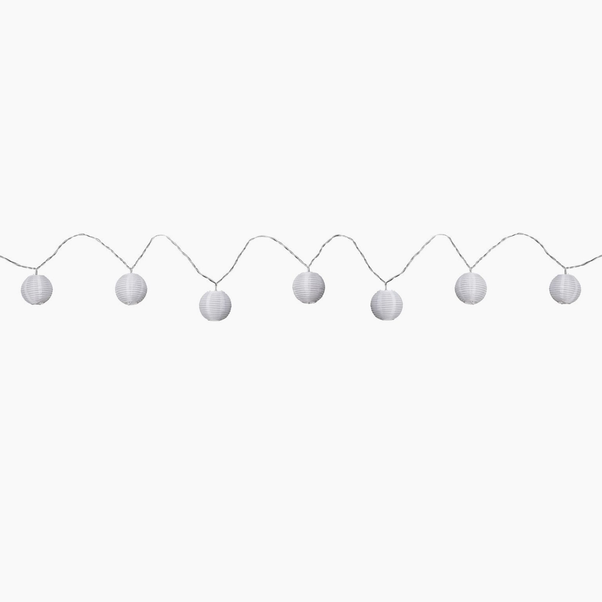 Round white paper lanterns, part of the Paulmann Outdoor Lampion LED 3.6m Fairy Lights in Warm White, are hanging on a wire against a white background. Perfect for creating an enchanting outdoor atmosphere, these lanterns can be conveniently recharged via USB to ensure they illuminate all night long.
