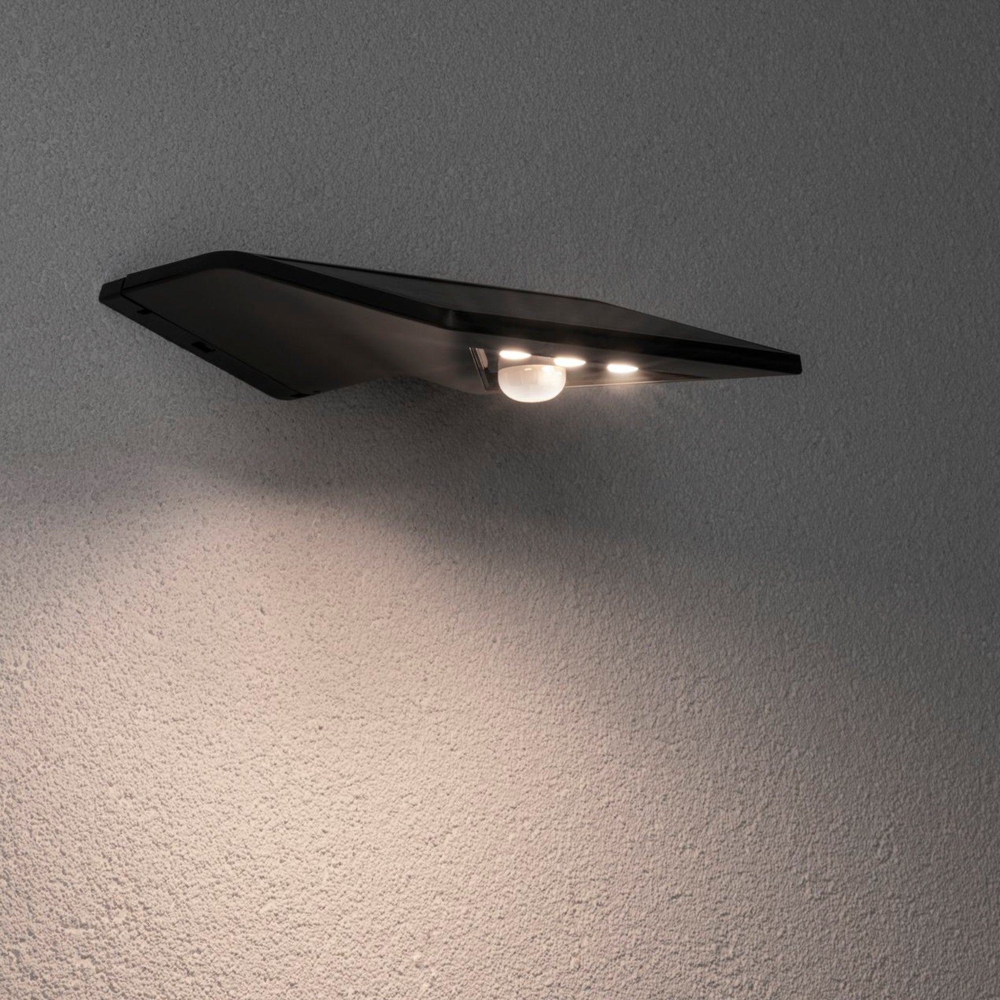 Discover the Paulmann Outdoor Yoko 1.2W LED House Number Wall Lumination Light in Anthracite, featuring a modern, angular design and solar technology with motion detection to illuminate your exterior walls beautifully with a small circular light.