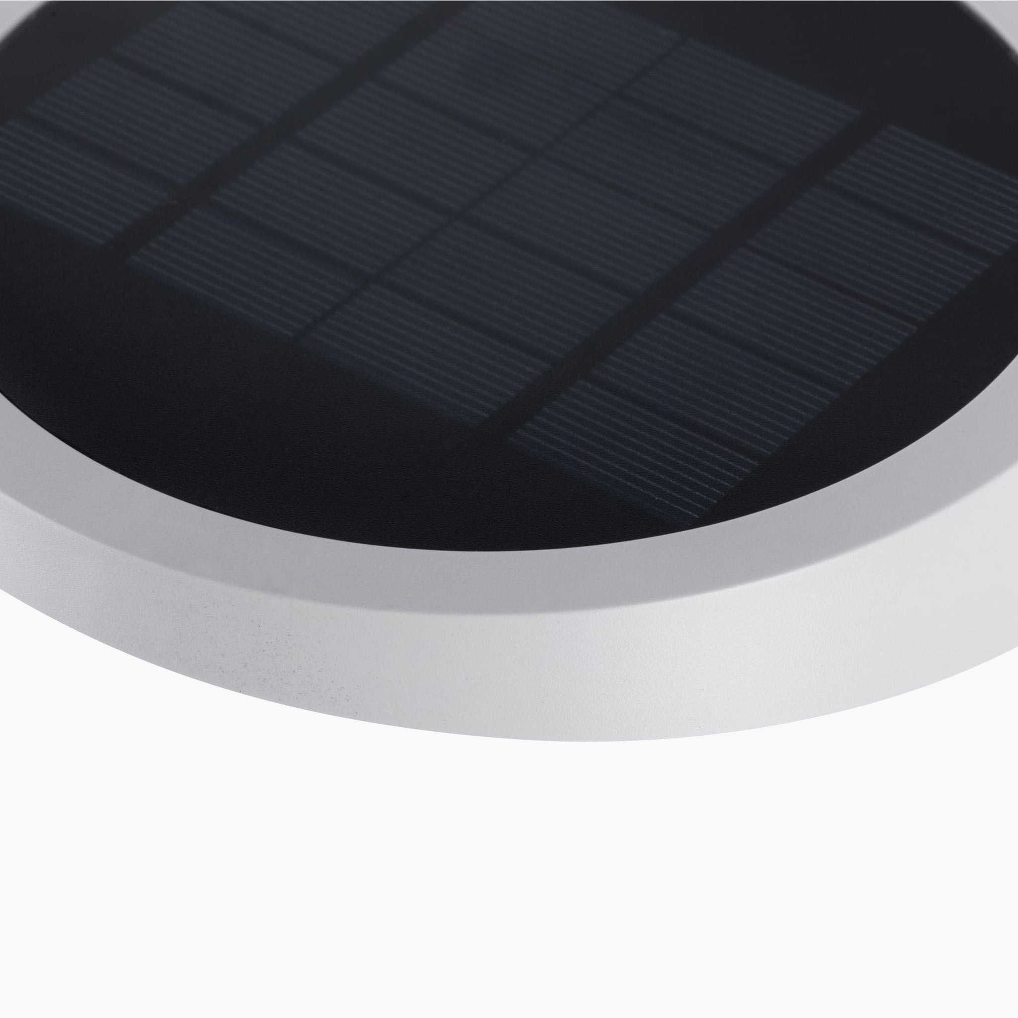 Close-up of the circular Paulmann Outdoor Ryse 1.2W LED Solar Wall Light featuring a silver frame, ideal for powering luminaires, set against a white background.