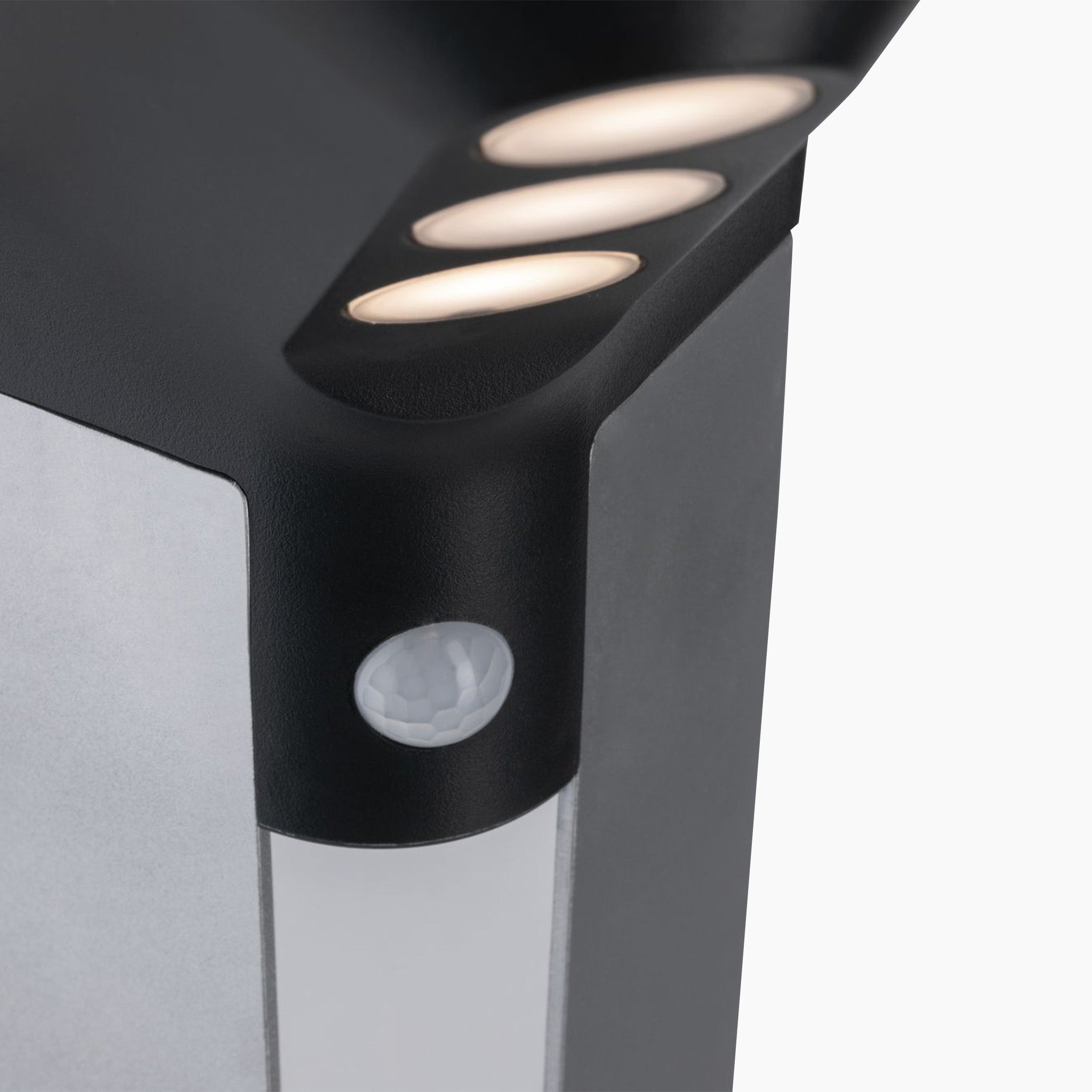 Close-up of the Paulmann Outdoor Soley 1.22W LED bollard lighting in anthracite, featuring a modern black and silver design with three circular lights and a motion sensor to efficiently recharge its battery using solar technology.