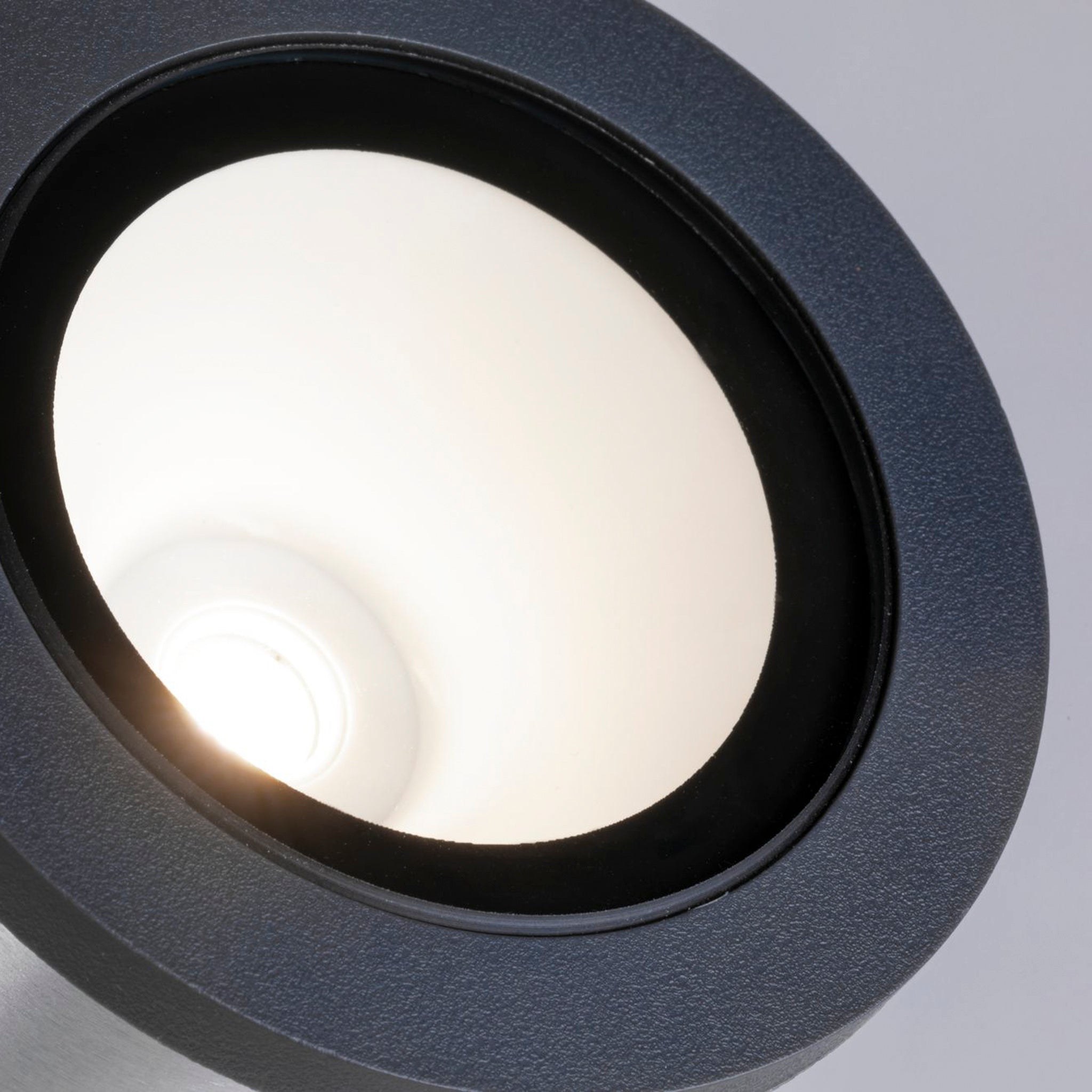 Close-up of the Paulmann - Plug & Shine Outdoor Classic 5.2W LED Individual Spotlight in Anthracite, featuring a bright, warm white bulb that casts a soothing glow.