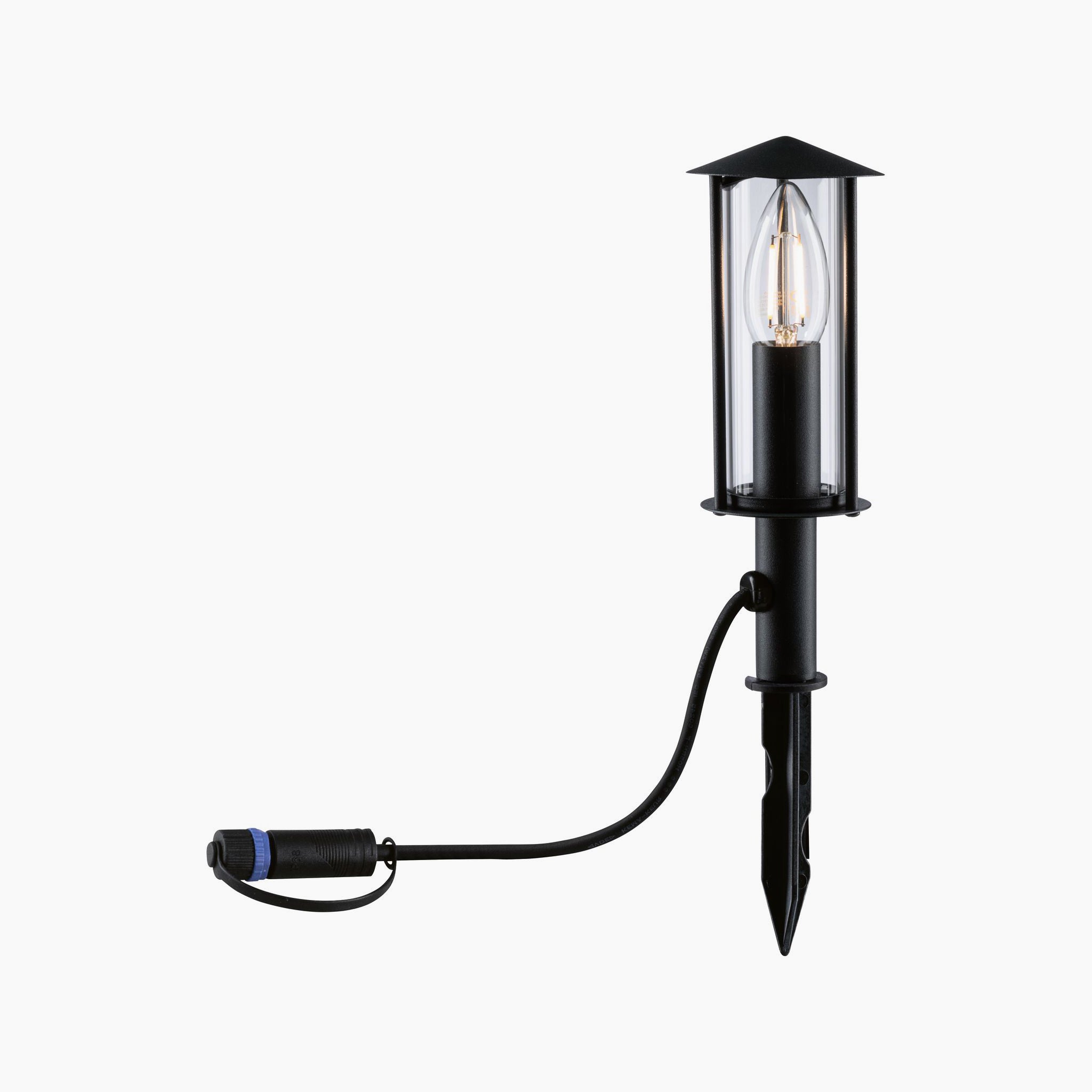 The Paulmann - Plug & Shine Outdoor Classic 2W LED Single 22cm Bollard Light in Anthracite features a mini bollard design with a pointed stake and clear glass casing for the bulb, all connected by a cable. It is perfect for enhancing your garden's aesthetic with efficient outdoor lighting.