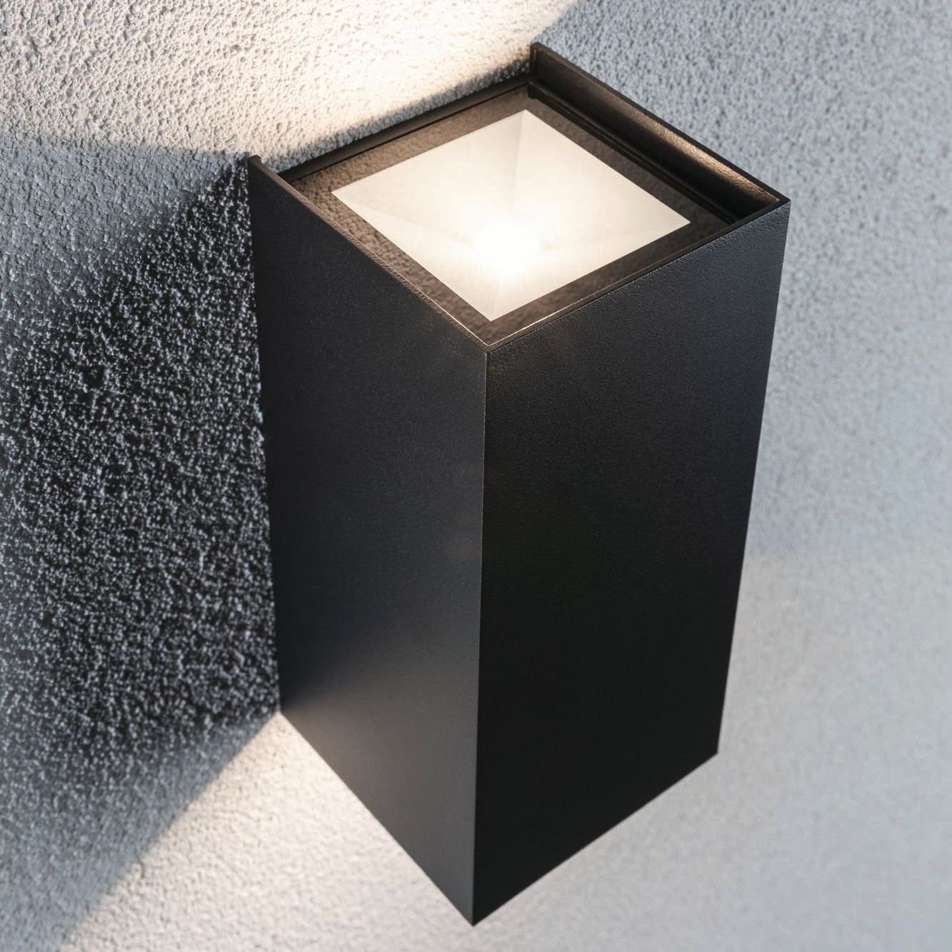 The Paulmann - Outdoor Flame 13.2W LED Large Wall Light in Anthracite is mounted on a textured gray wall, showcasing cutting-edge LED technology.