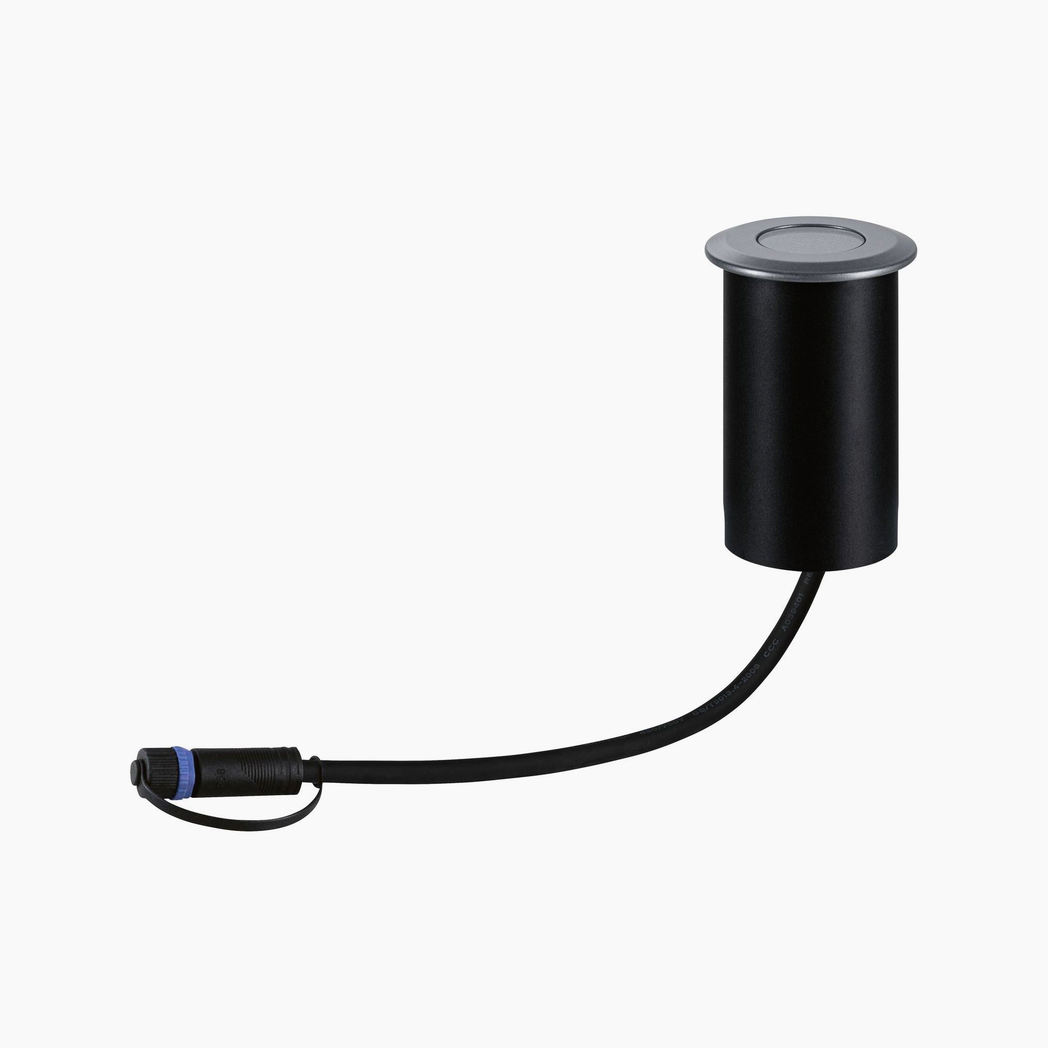 A grey recessed floor spotlight with a round cover and attached power cord blends seamlessly into the Paulmann Plug & Shine system, offering versatility and style for modern spaces.