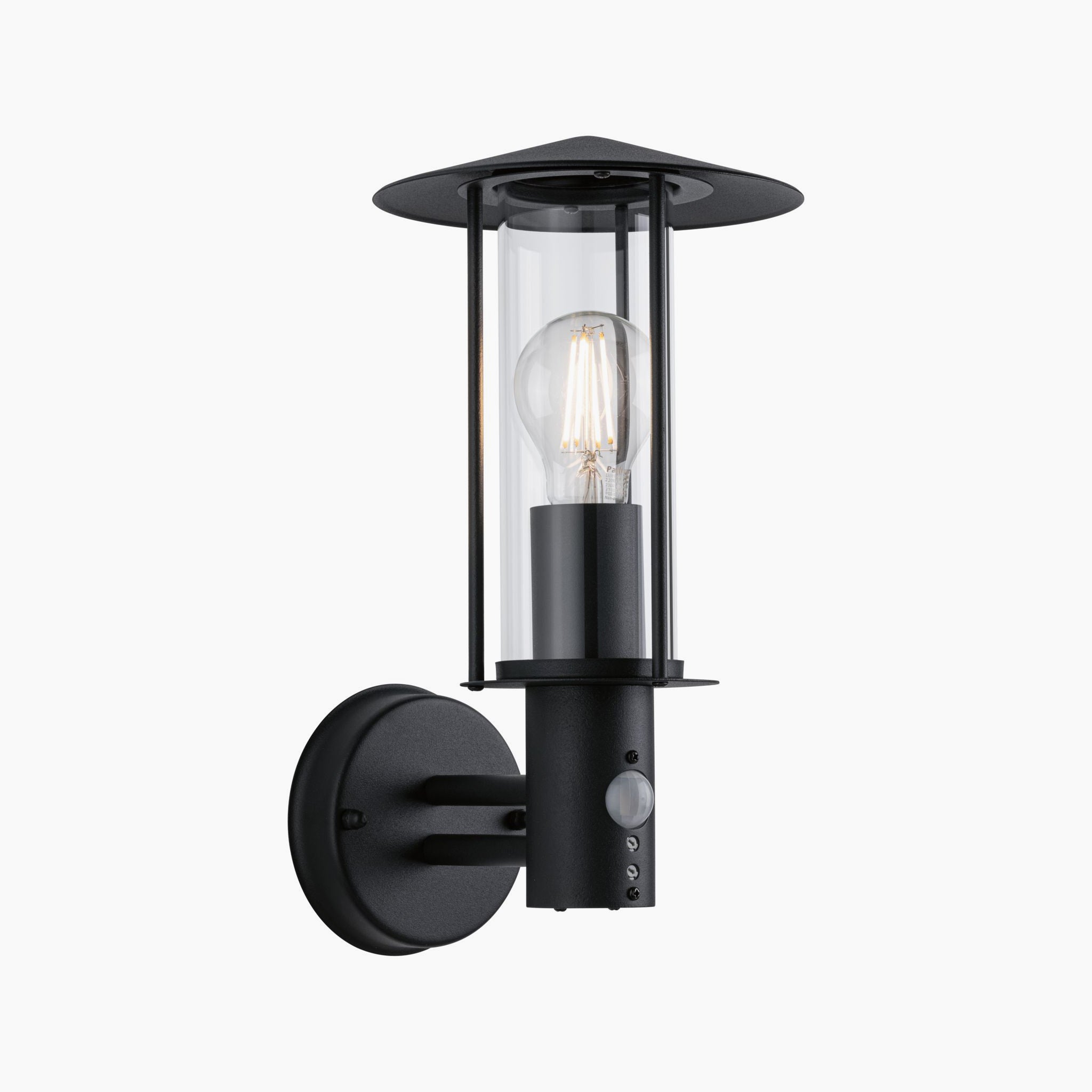 Outdoor wall light by Paulmann with IP44 protection, featuring a classic design in dark grey. It has clear glass that encases an exposed bulb and is mounted on a circular base, incorporating a 15W LED with motion detection.