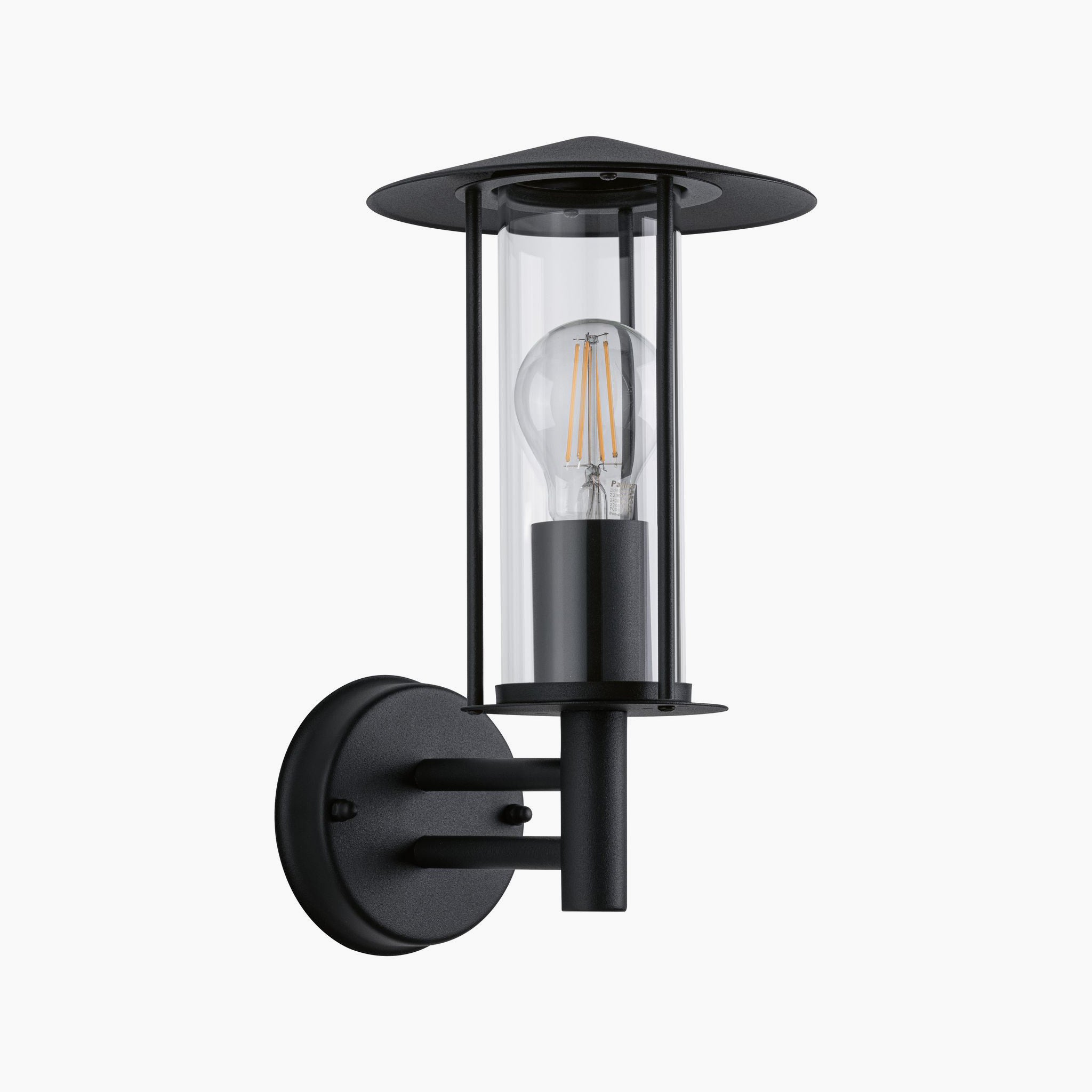 The Paulmann Outdoor Classic 15W LED Wall Light in Dark Grey features a clear cylindrical glass casing with a visible bulb, making it perfect for exterior walls. With IP44 protection, it ensures durability against the elements.