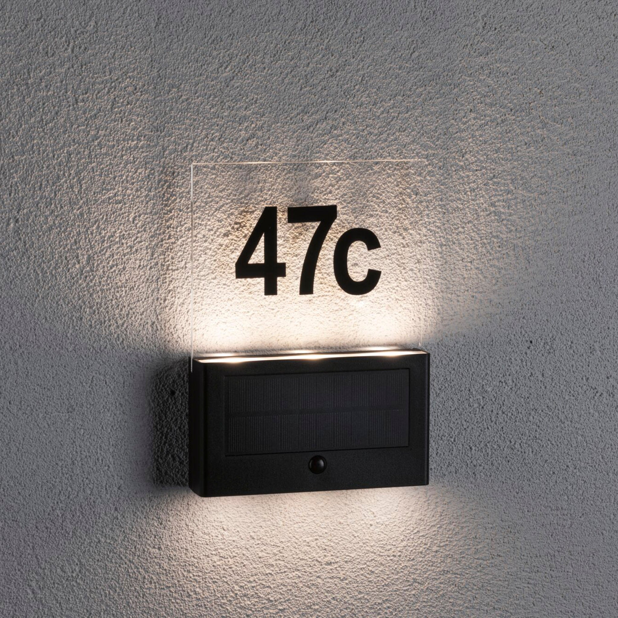 The Paulmann Outdoor Neda Solar House Number 1W LED in anthracite boasts a sleek design featuring an illuminated "47c" address, complete with a dusk sensor, making it an ideal solar-powered wall-mounted plaque solution.