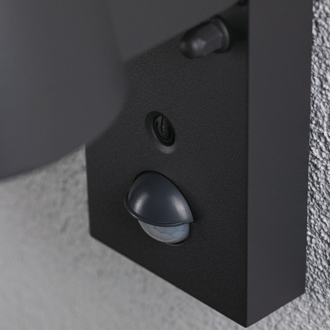 Close-up of the Paulmann - Outdoor Capea 8W LED Wall Light in anthracite, featuring motion detection and insect-friendly lumination, mounted on a textured grey wall.