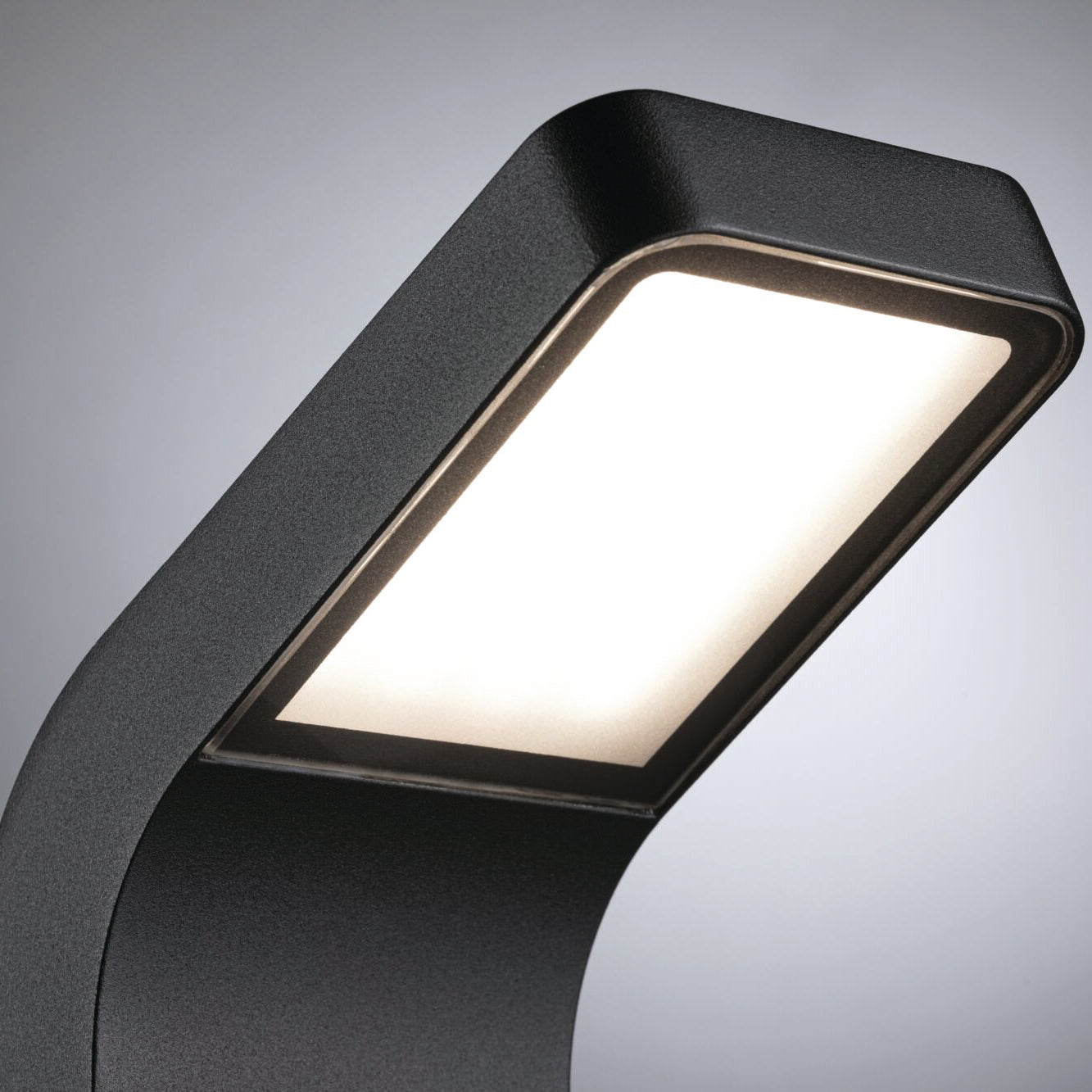Displayed against a plain background, the Paulmann Outdoor Kulma 9W LED Bollard Light in Anthracite boasts a sleek rectangular design reminiscent of coastal lighting, enhanced with modern black features and motion detection capabilities.