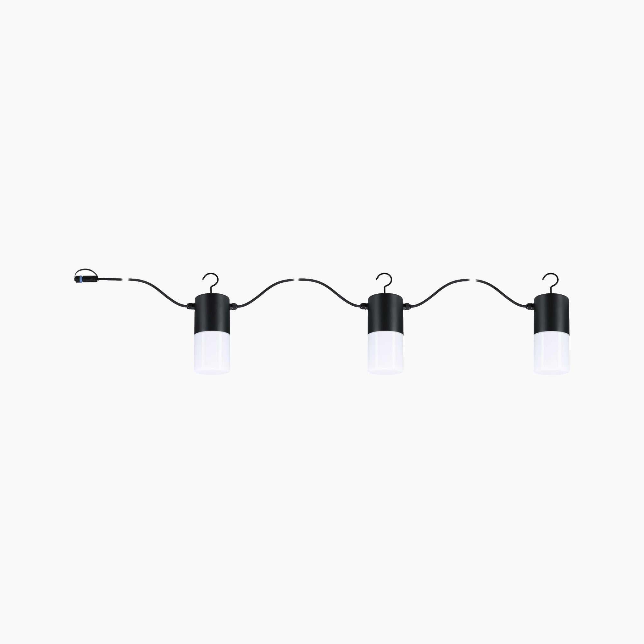 A set of three Paulmann Plug & Shine Outdoor 2W LED Fairy Lights in Anthracite arranged on a curved wire emits warm white light against a simple backdrop, enhancing outdoor decor with an elegant touch.