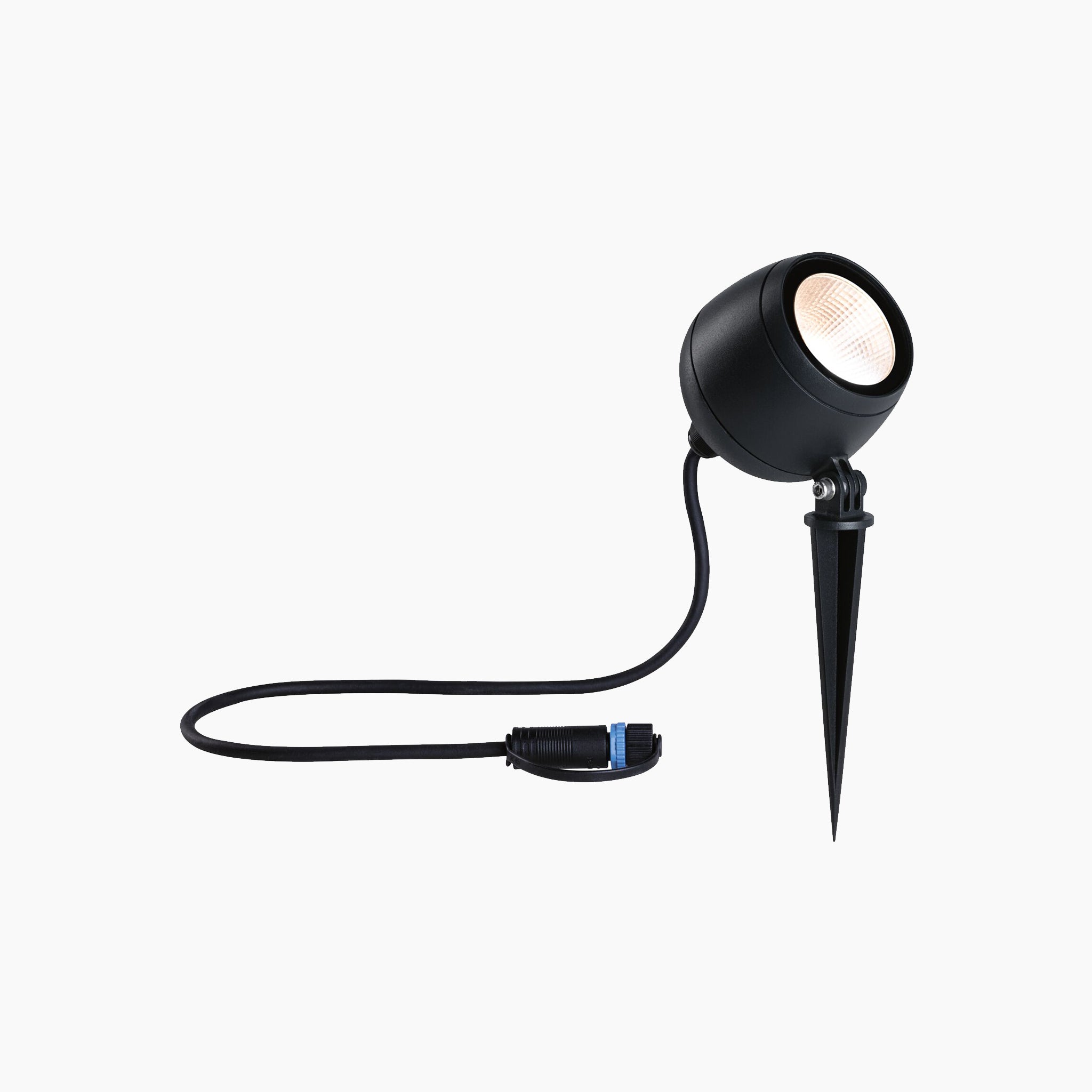 The Paulmann Plug & Shine Outdoor Kikolo 7.2W LED 20 degrees garden spotlight in anthracite, complete with a pointed stake, plug, and cord, is ideal for any outdoor lighting project, illuminating the area with warm white light against a white backdrop.