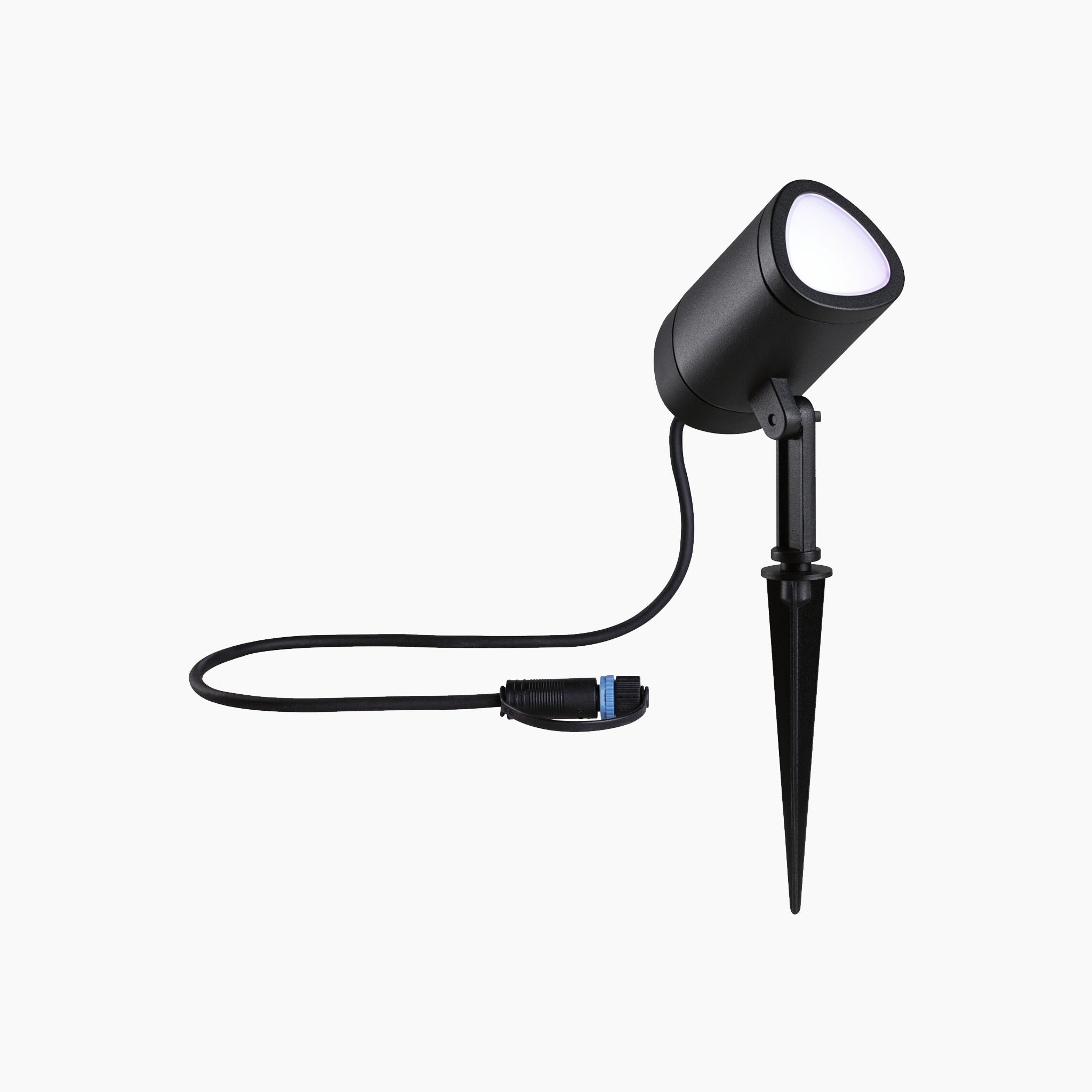 An anthracite Paulmann Plug & Shine Outdoor 6.5W LED garden spotlight with a ground spike and attached cord on a white background, equipped with Smart Home Zigbee 3.0 technology for weather resistance and durability.