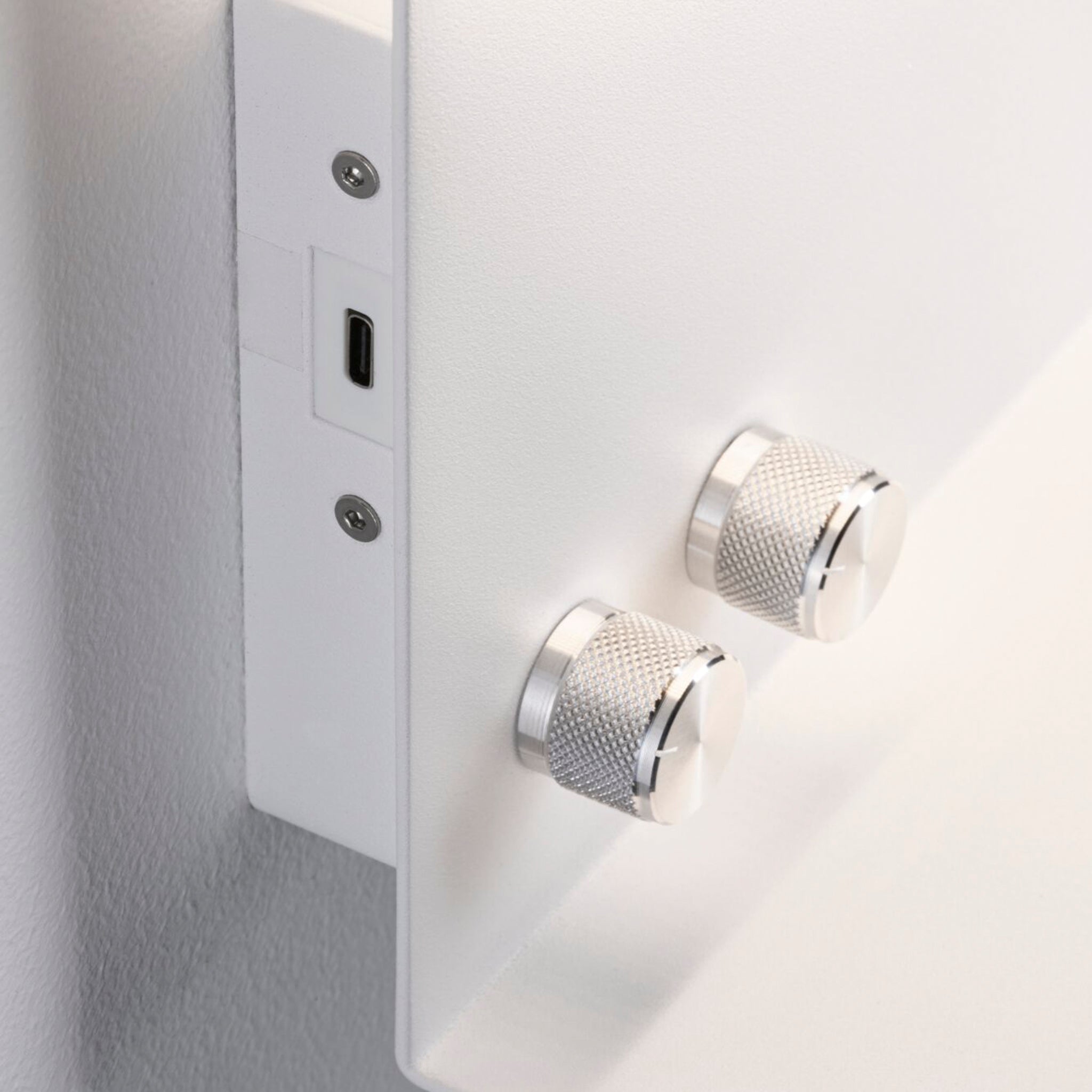 Close-up of the Paulmann - Jarina 7.5W LED dimmable wall light in white matt, featuring two silver knobs and a USB-C charging port on the side.