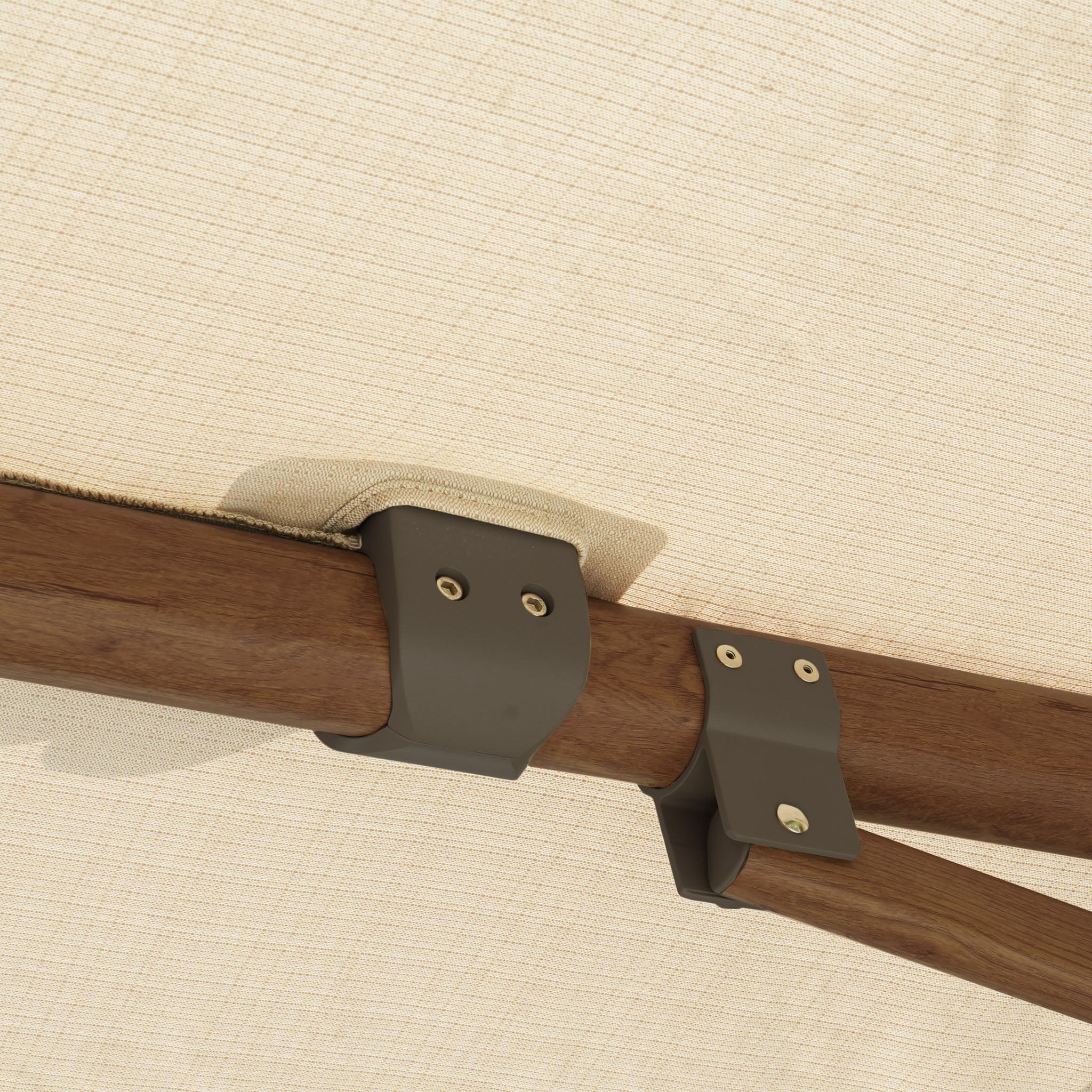 Close-up of metal brackets on the Finca 4m x 3m Cantilever Parasol in Walnut, highlighting its sturdy wooden pole and beige canopy for reliable outdoor sun protection.