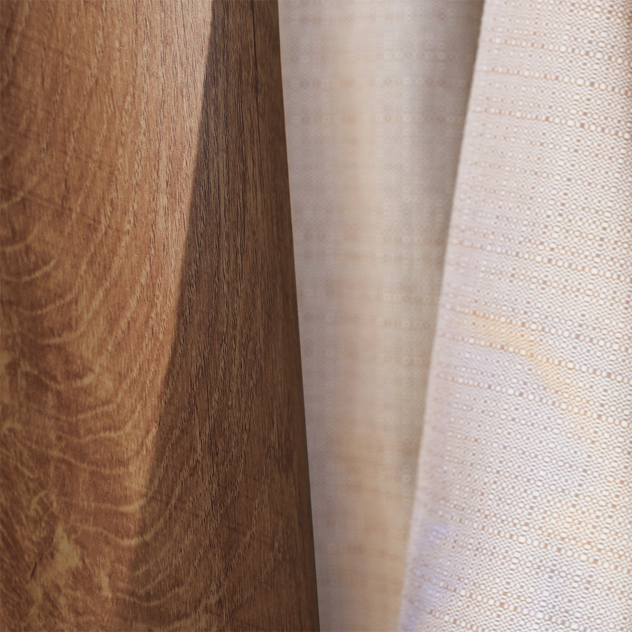 Close-up of light wood panel beside a beige textured fabric curtain—inspiration for outdoor sun protection with the Finca 4m x 3m Cantilever Parasol in Walnut.