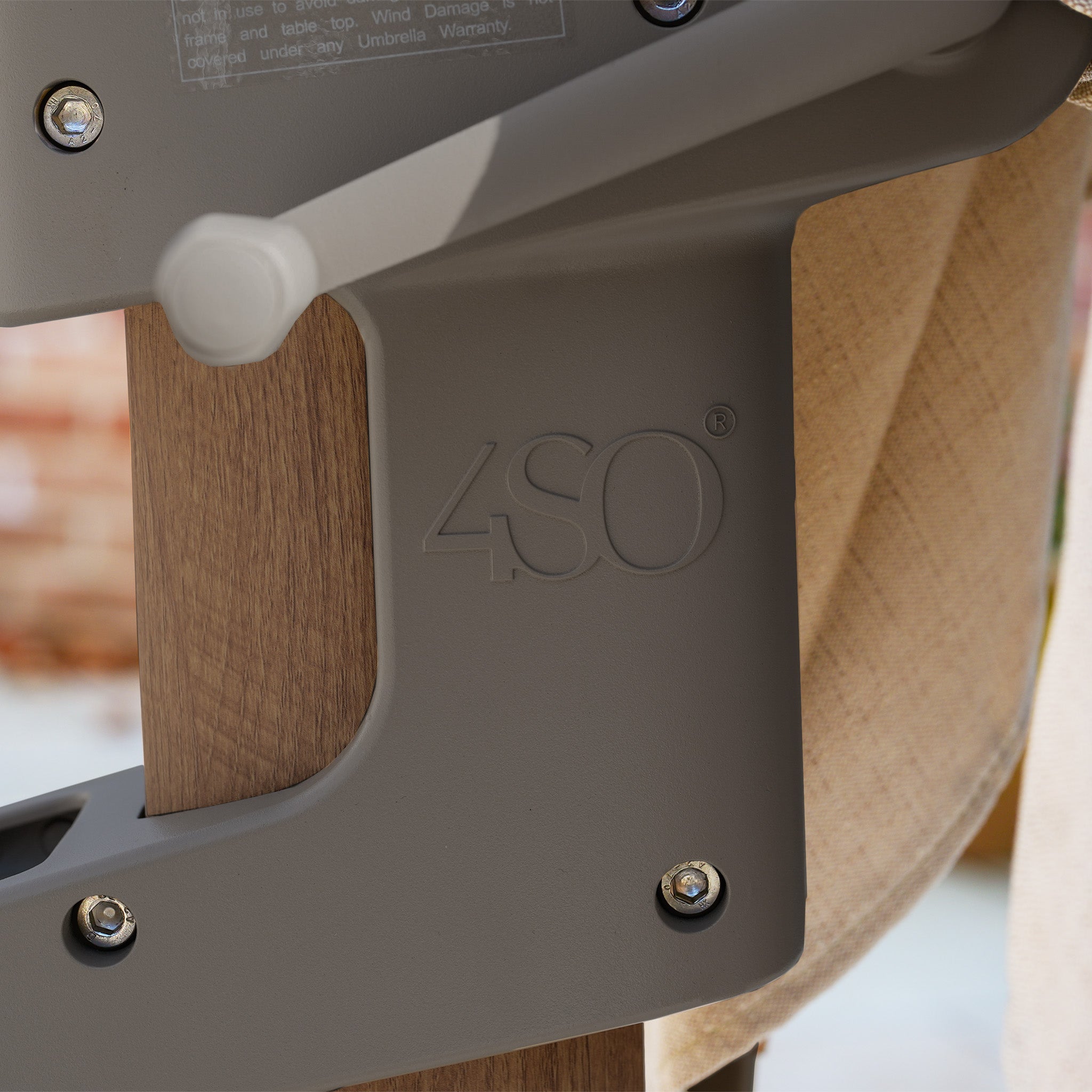 Close-up of a brown chair featuring the embossed "4SO" logo and beige fabric, ideal for relaxing under the Finca 4m x 3m Cantilever Parasol in Walnut.