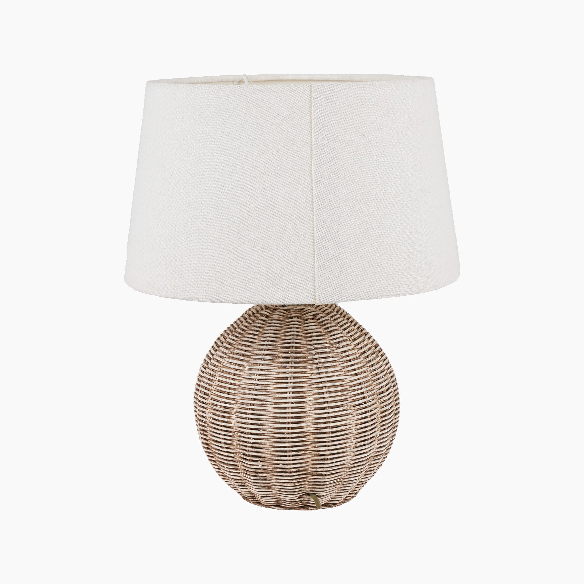 The Pacific Lifestyle - Raffles Small Rattan Cream Wash Table Lamp showcases a wicker base in antique cream wash and is topped with a cream slubby cotton shade, set against a plain backdrop.