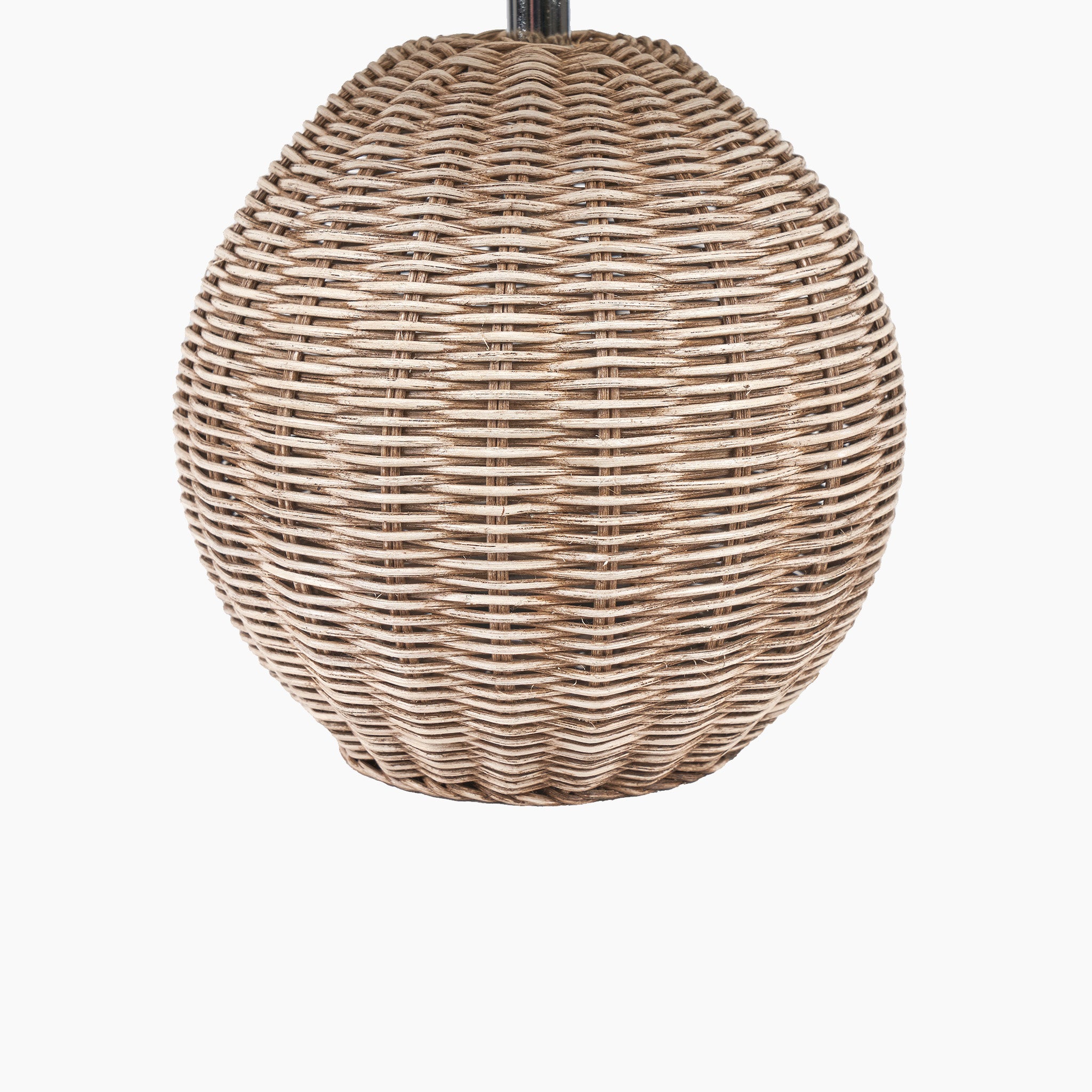 The Pacific Lifestyle Raffles Small Rattan Cream Wash Table Lamp, with its elegant oval shape, stands out against a plain white backdrop, ideal for introducing a coastal charm similar to a beach hut lamp.