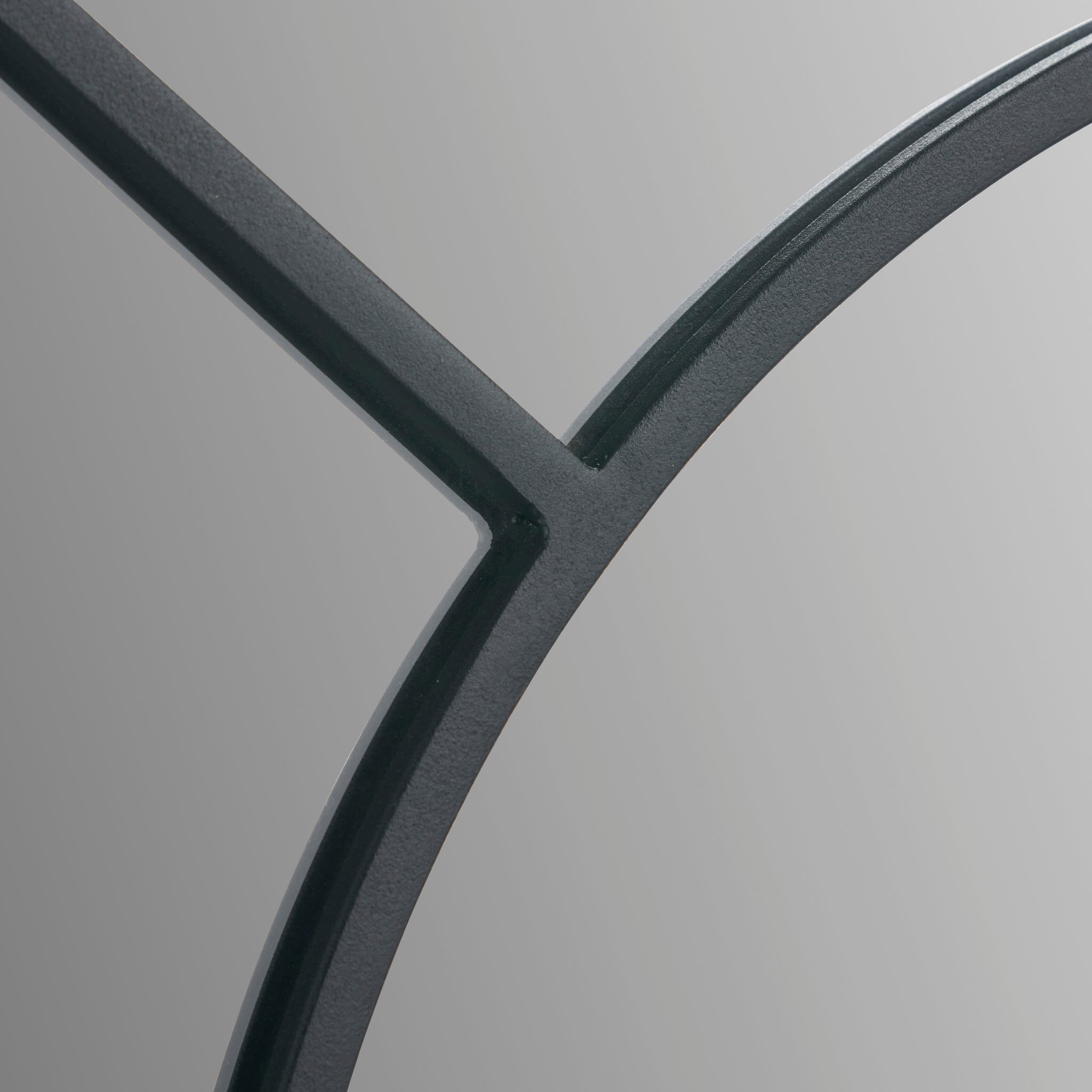 Close-up of the Pacific Lifestyle - Black Metal 2 Half Moon Section Wall Mirror on a light gray background, forming an abstract geometric design.
