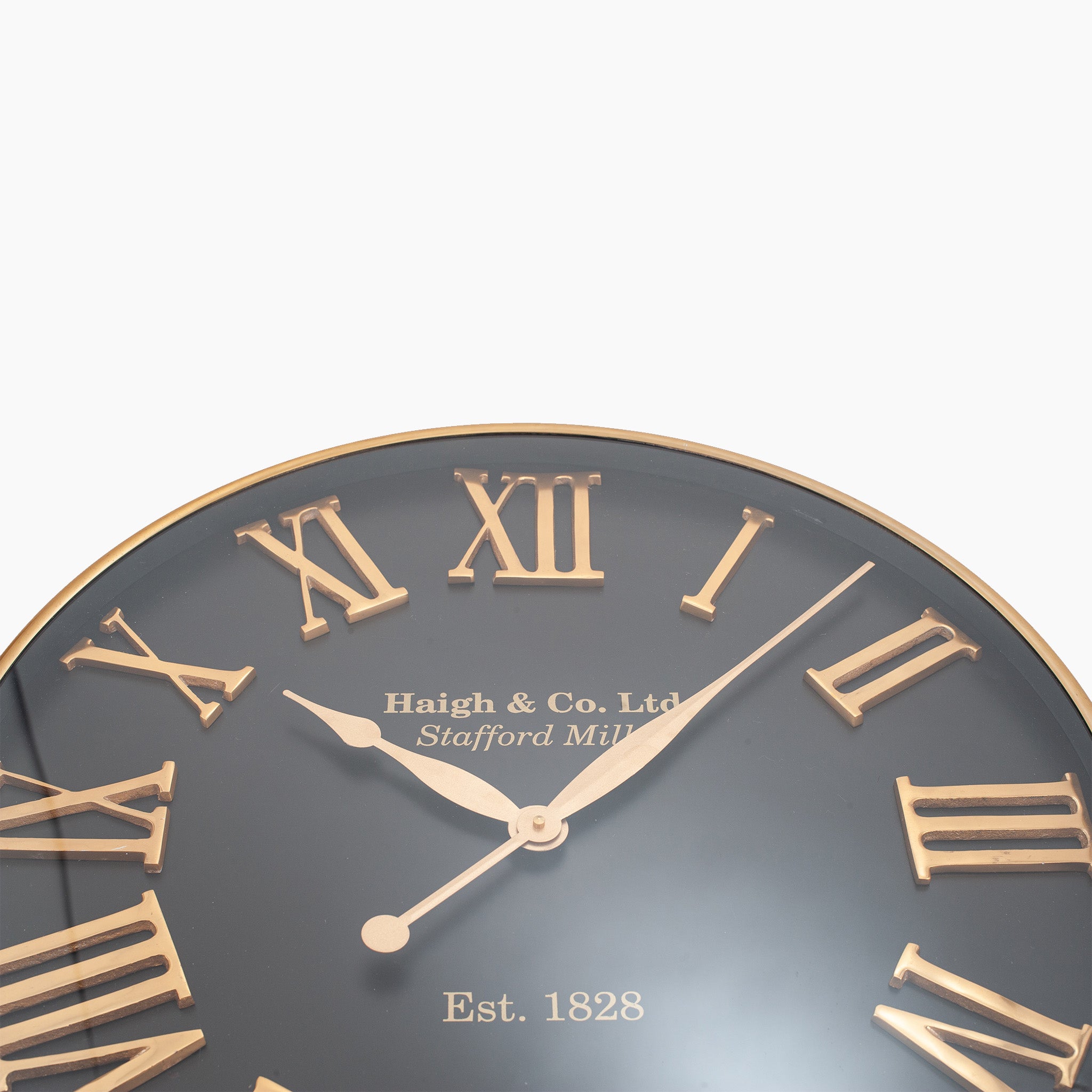 The Pacific Lifestyle Antique Gold and Black Metal Wall Clock features oversized Roman numerals and displays "Haigh & Co. Ltd, Stafford Mills, Est. 1828," perfect as a stunning focal point for contemporary interiors.