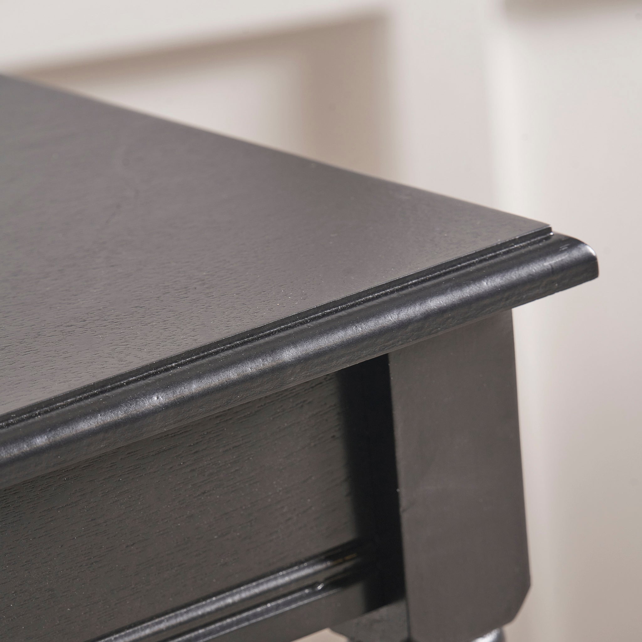 Close-up of a Pacific Lifestyle Heritage Black Pine Wood Accent Table corner, highlighting its smooth finish and minimalist design.